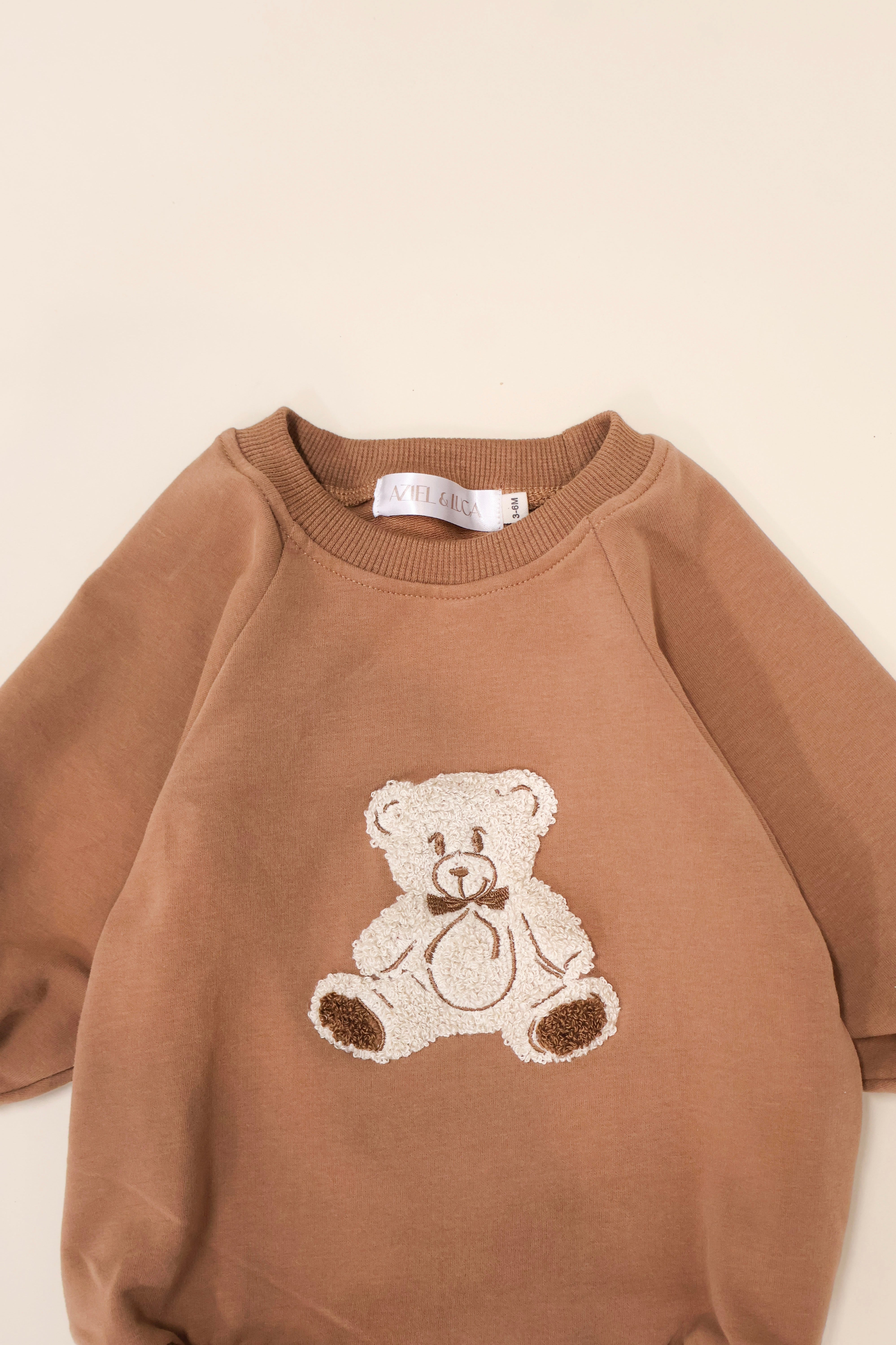 Bear Bubble Romper in soft French terry with teddy bear embroidery, perfect for comfy and stylish play.