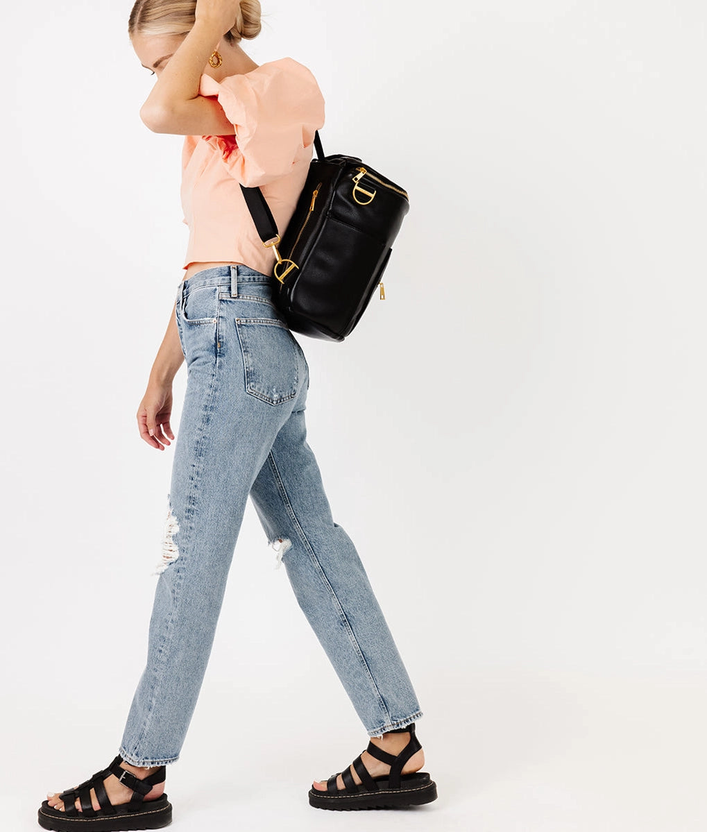 Model wearing the Original Diaper Bag Backpack in black, showcasing its stylish and functional design.