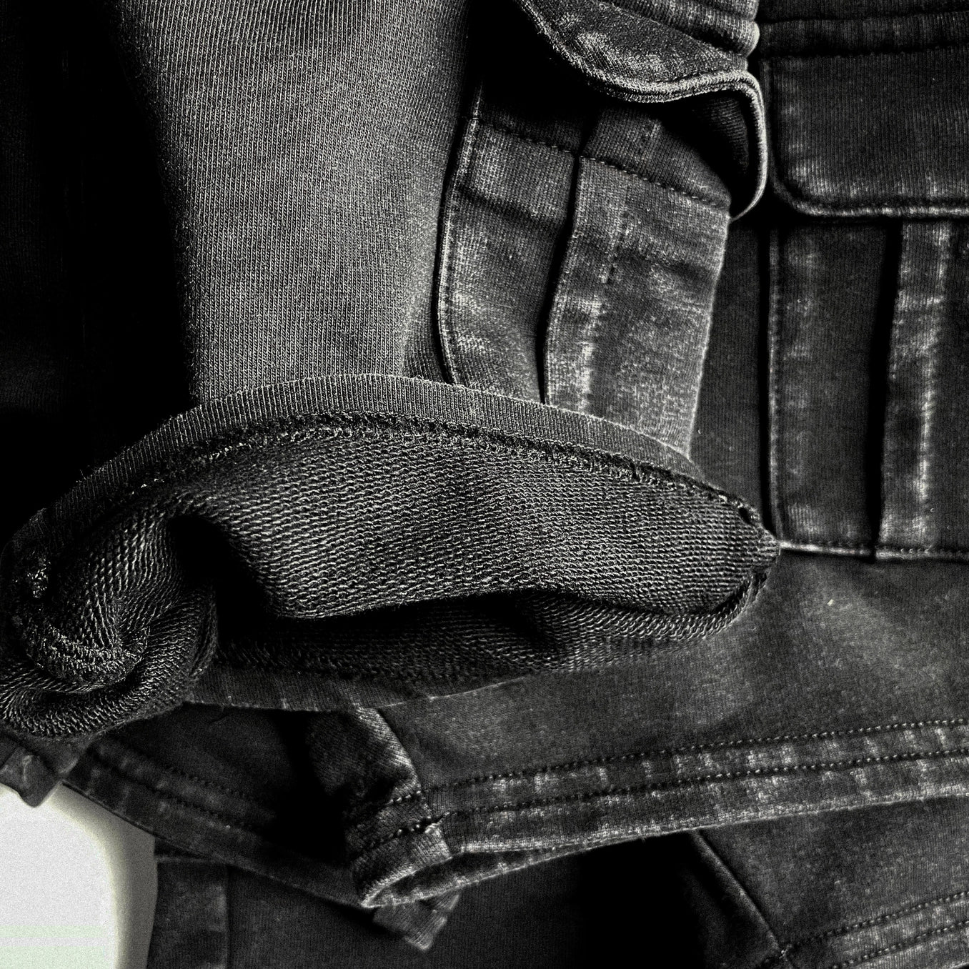 Black acid wash cargo shorts showcasing detailed fabric texture and stitching for kids' adventure style.