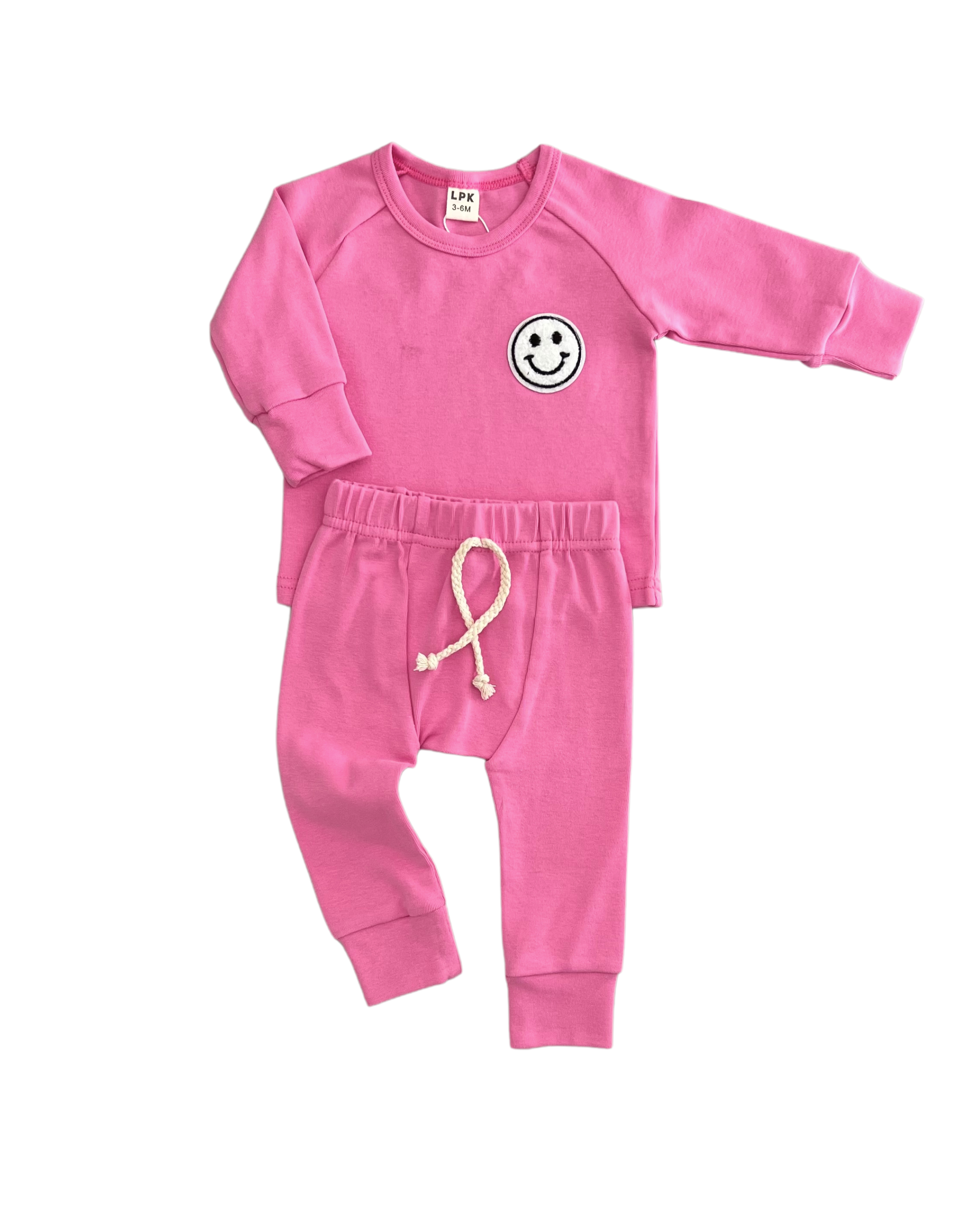 Lounge set smiley bubble gum for girls featuring a soft tee and lightweight shorts in vibrant pink with smiley patch.