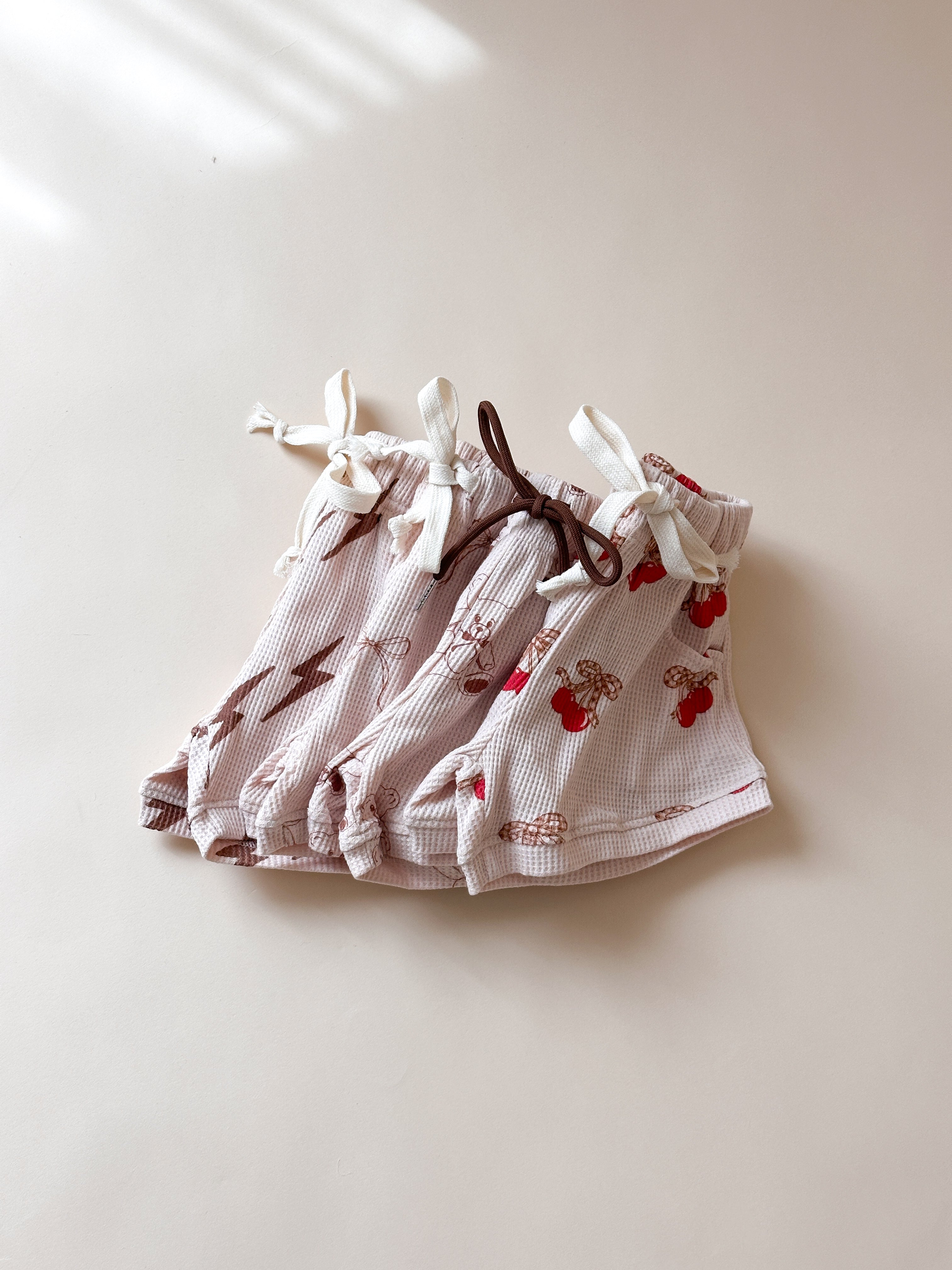 Printed waffle sets for kids featuring fun patterns like Monster Truck and Cherry, designed for summer comfort.