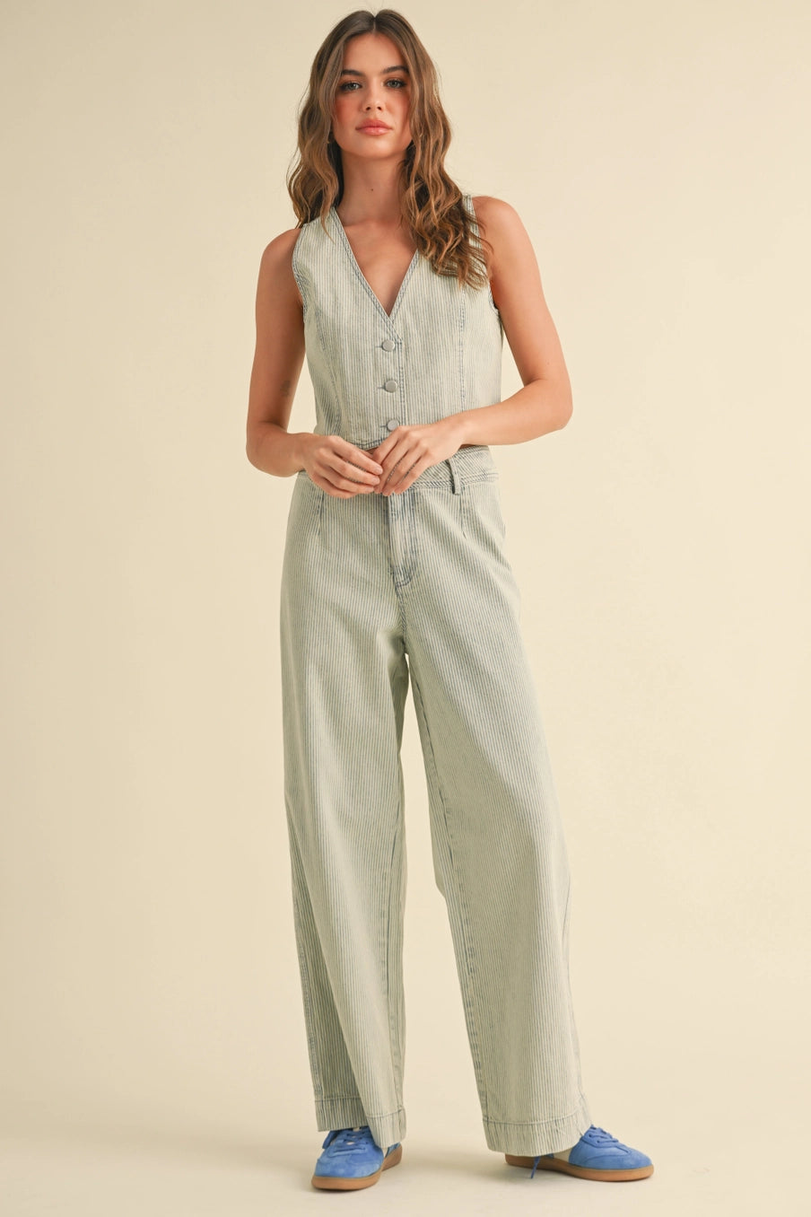 Model wearing a Faded Stripe Pattern Vest in denim, showcasing a relaxed fit and vintage style.