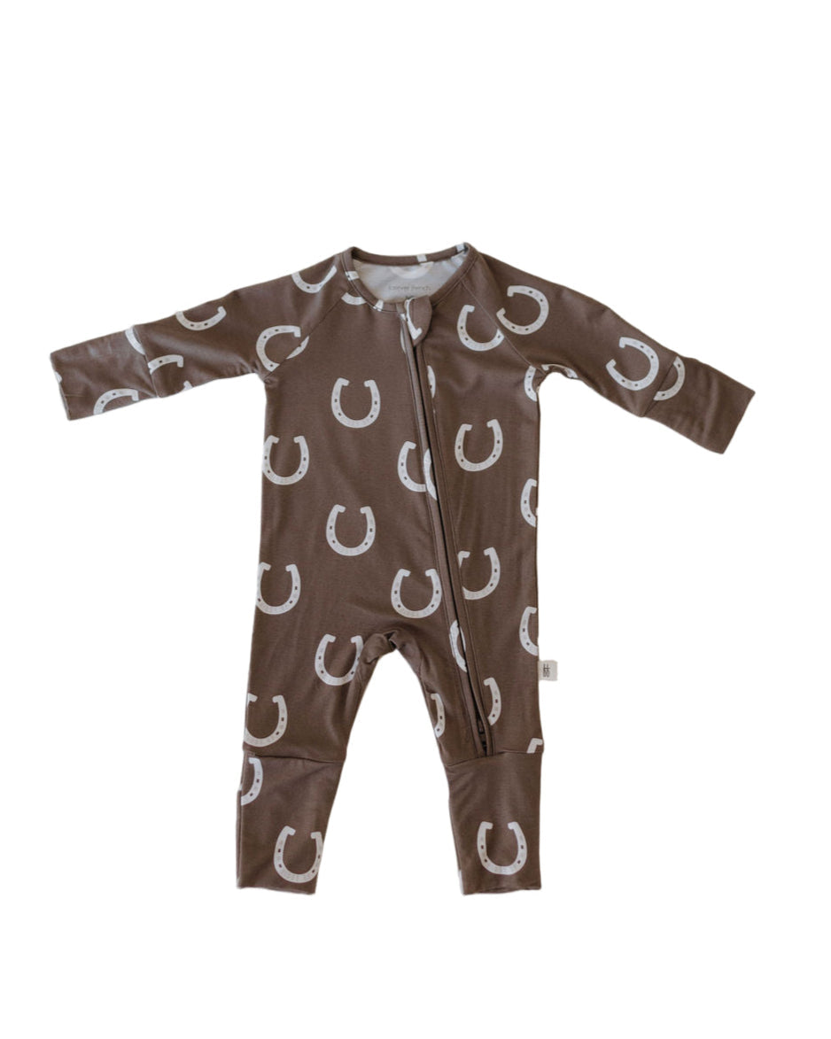 Bamboo zip pajamas giddy up for babies, featuring a brown horseshoe print and easy double zipper for quick changes.