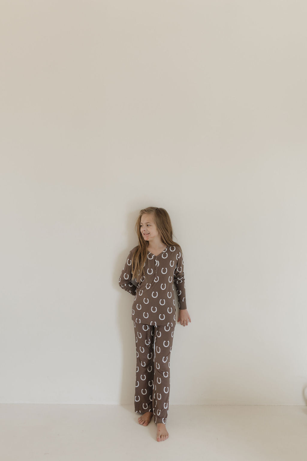 Youth flare bamboo pajamas giddy up in brown horseshoe print, perfect for stylish sleepovers and lounging.