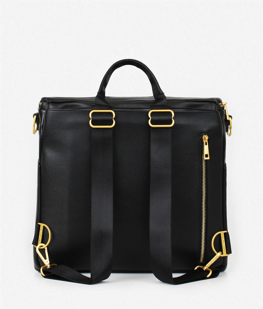 Original Diaper Bag Backpack in black faux leather with gold accents and adjustable straps.