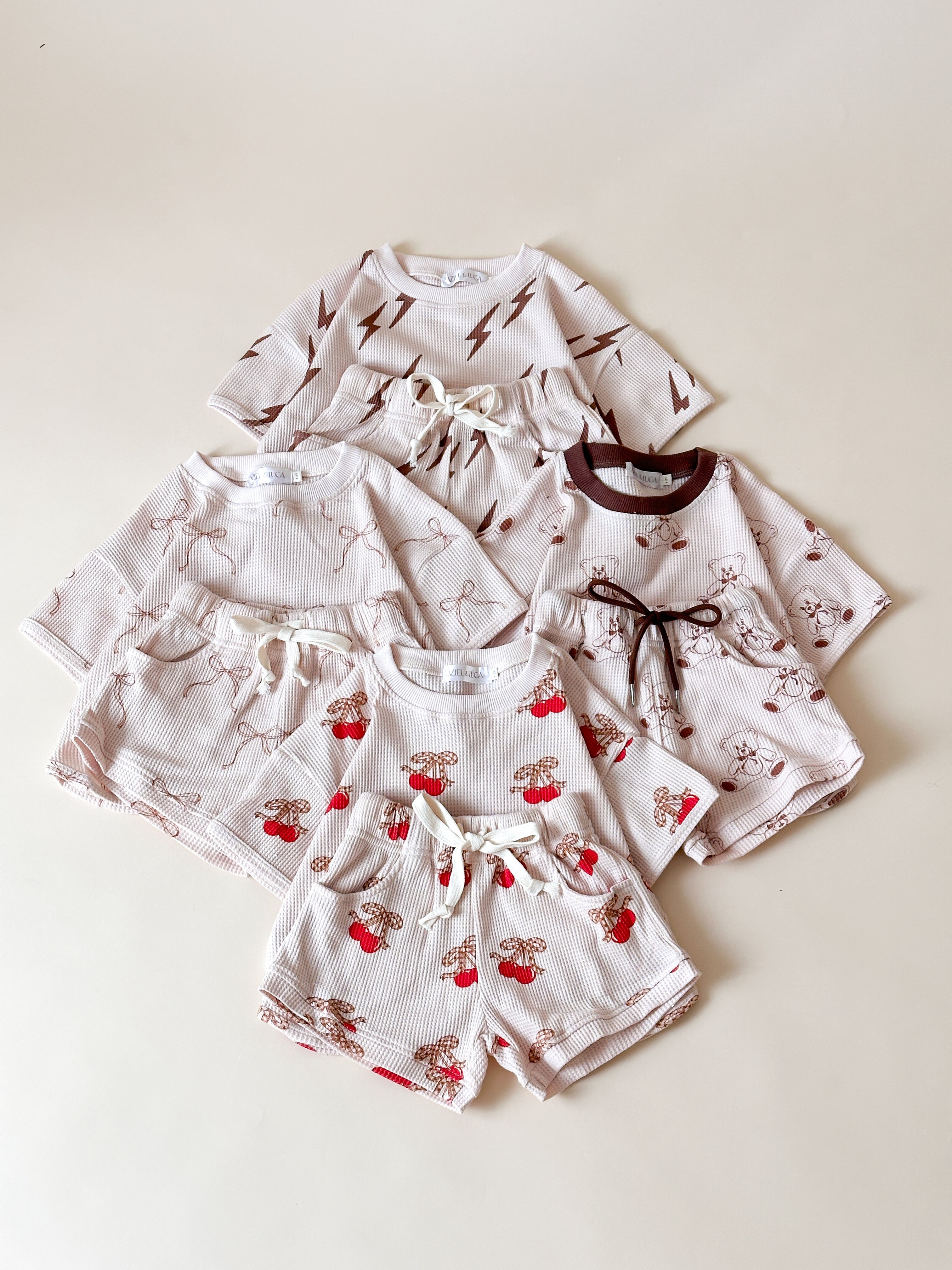 Printed waffle sets for kids featuring fun patterns like Bolt, Bow, Cherry, and Bear in a cozy design.