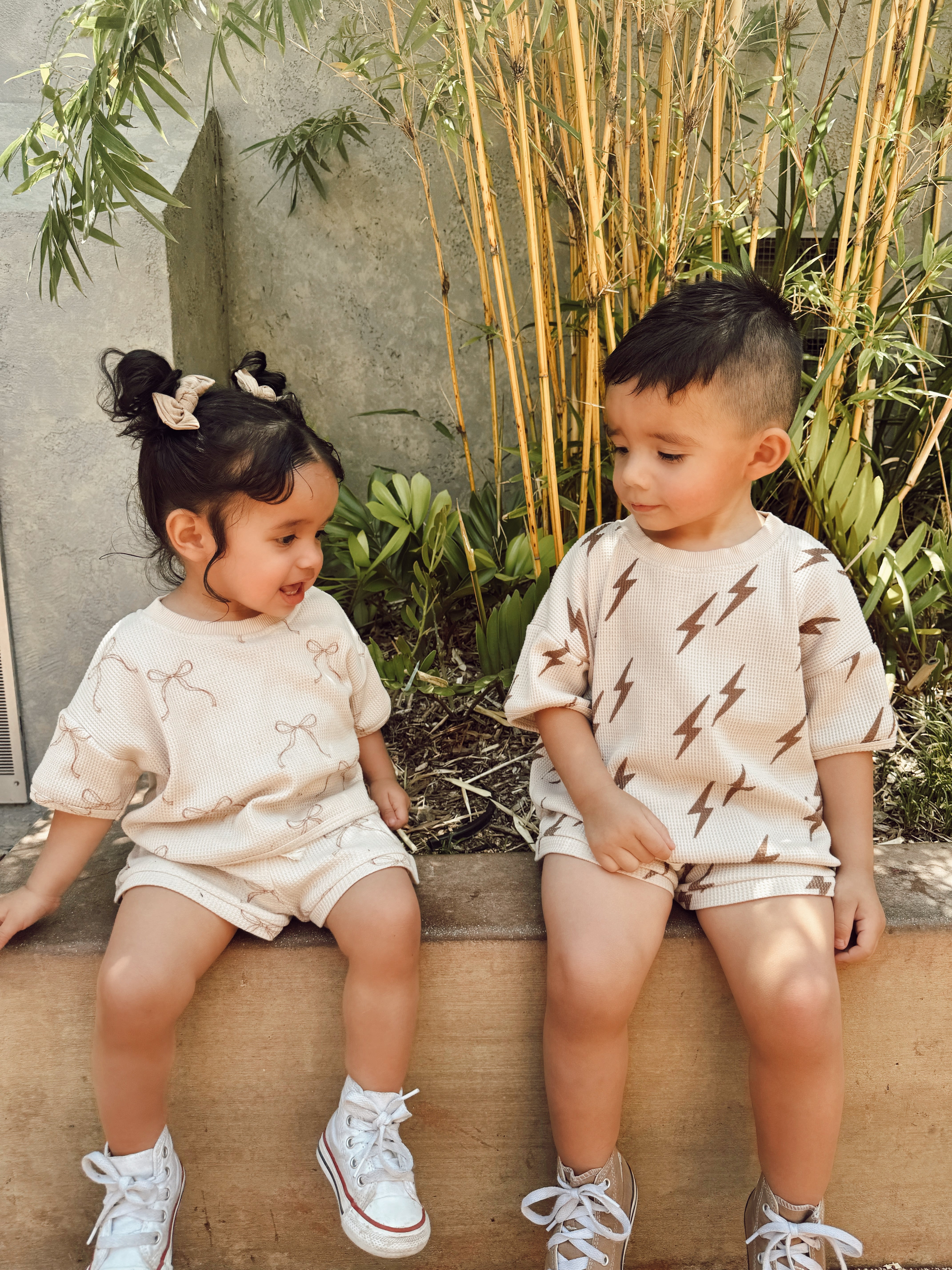 Kids wearing printed waffle sets featuring fun designs, perfect for summer outings and playtime.