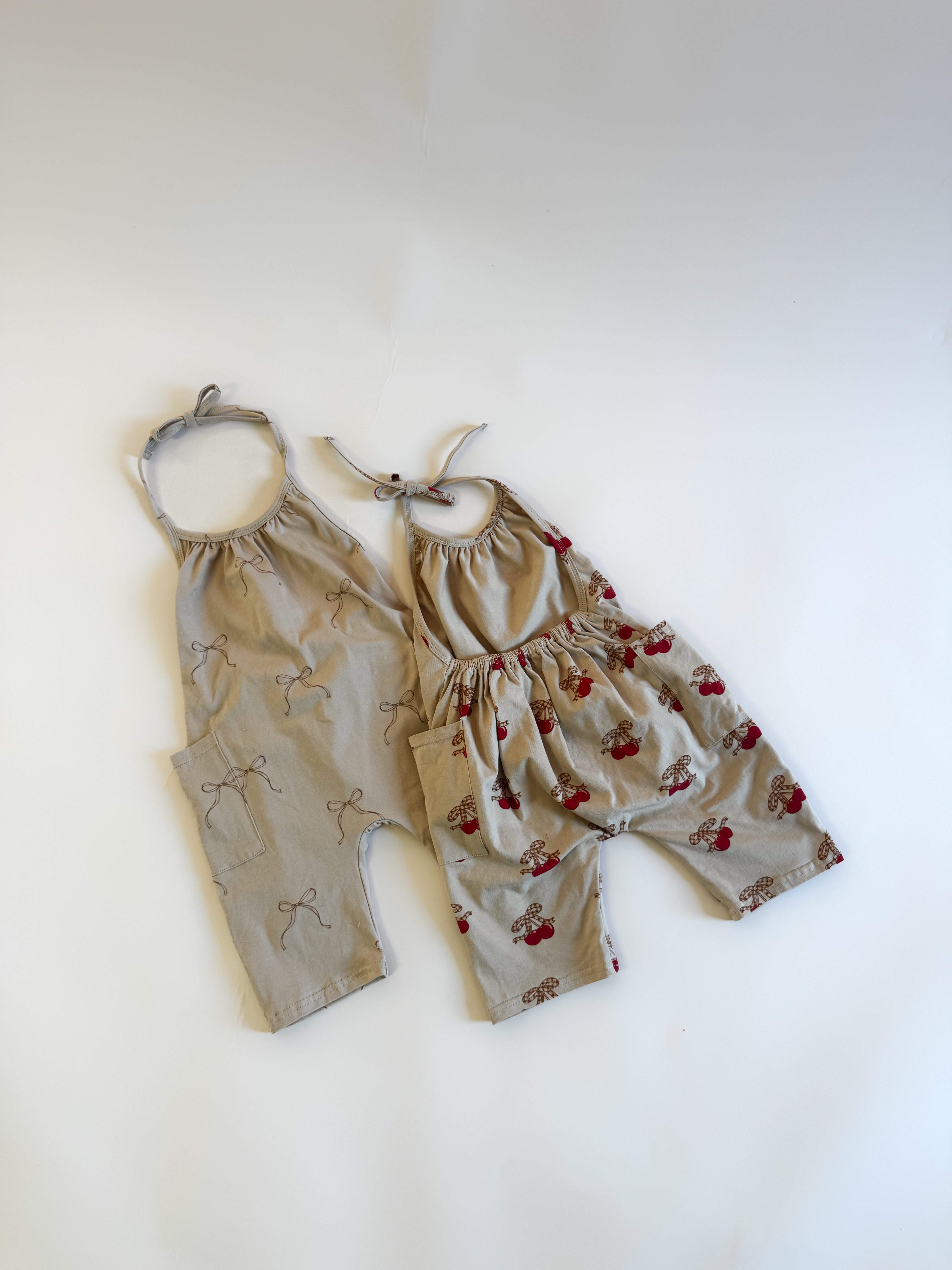 Halter jumpsuit girls in soft fabric with playful bow designs, perfect for summer adventures.