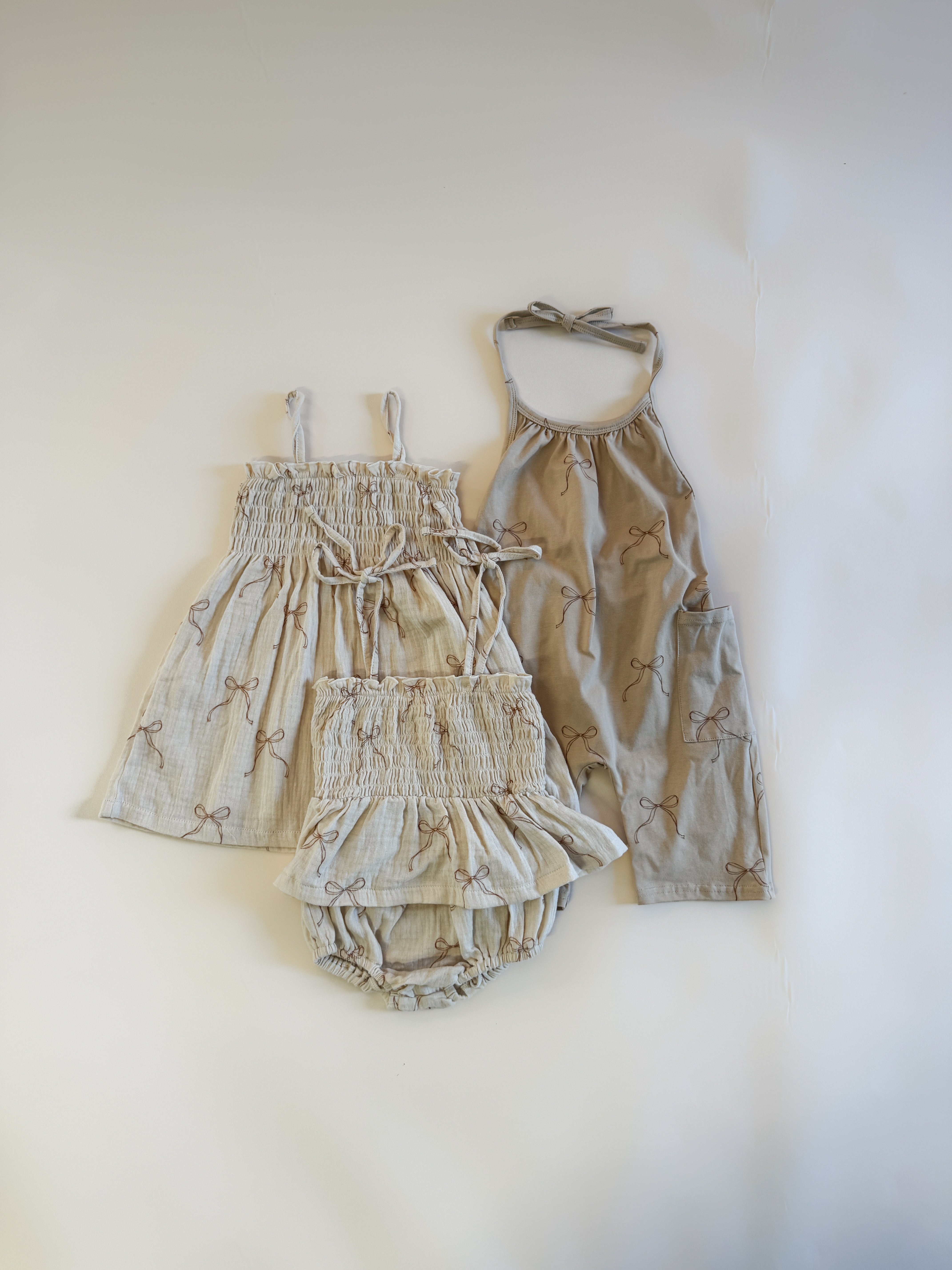 Halter jumpsuit girls outfit set featuring flouncy dress and shorts in soft fabric with bow designs.