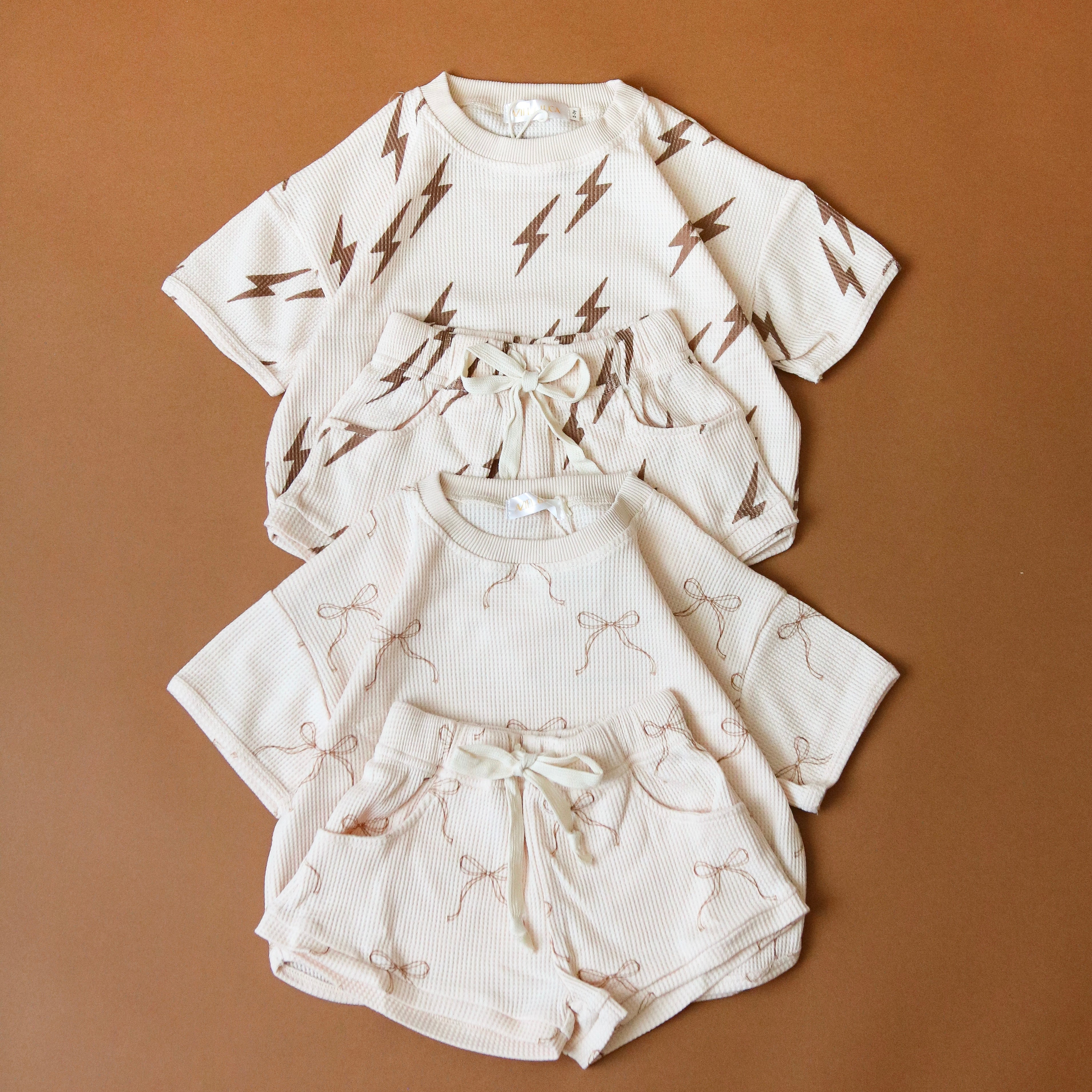 Printed waffle sets for kids featuring lightning and bow designs in soft, comfy fabric, perfect for summer fun.