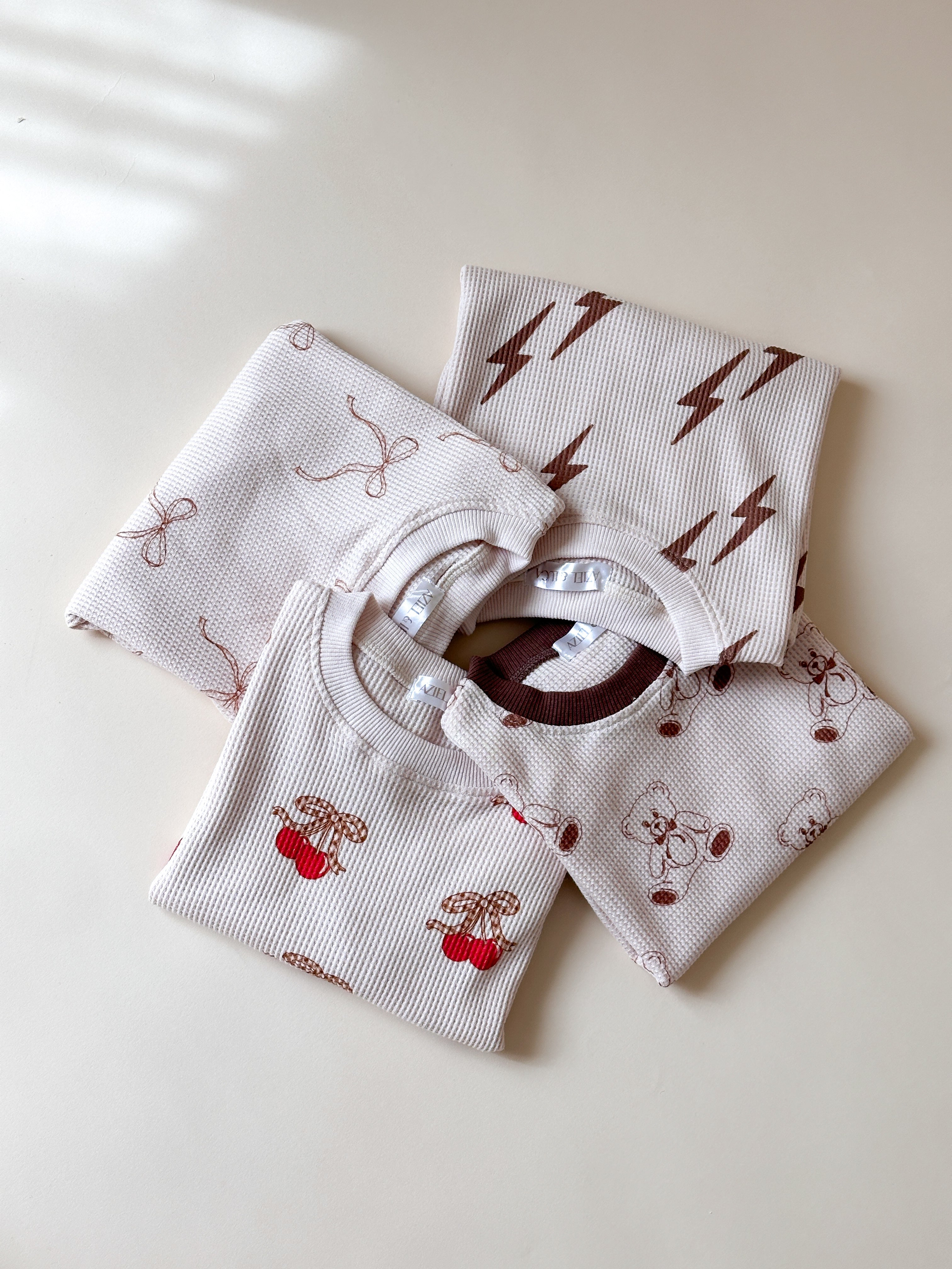 Printed waffle sets kids featuring cute designs: Cherry, Bow, Bolt, and Bear for playful summer fun.