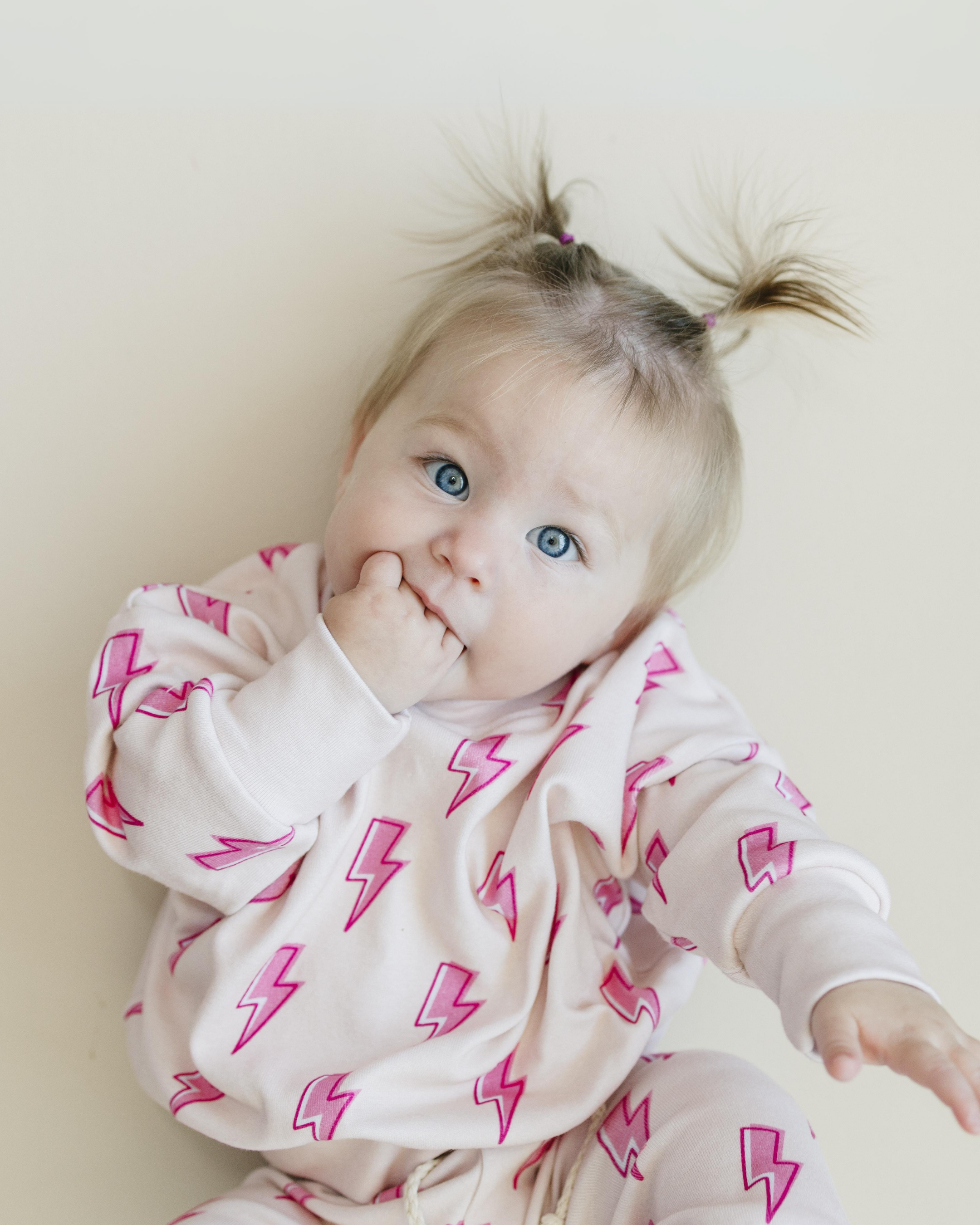 Toddler wearing pink bolt jogger set with lightning print, showcasing comfy and trendy loungewear.