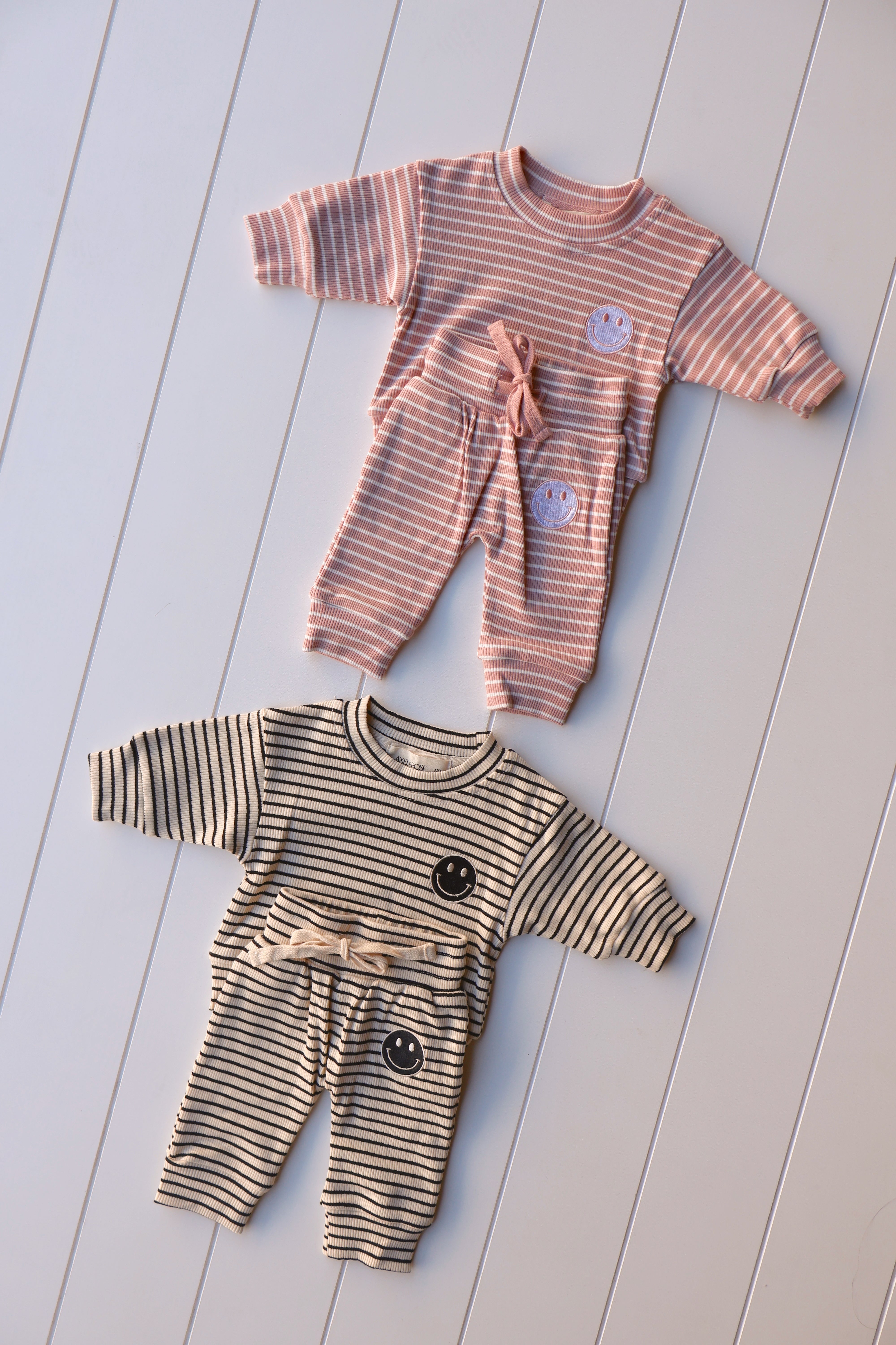 Smiley stripe set for toddlers featuring a striped tee and shorts in playful colors and happy face graphics.
