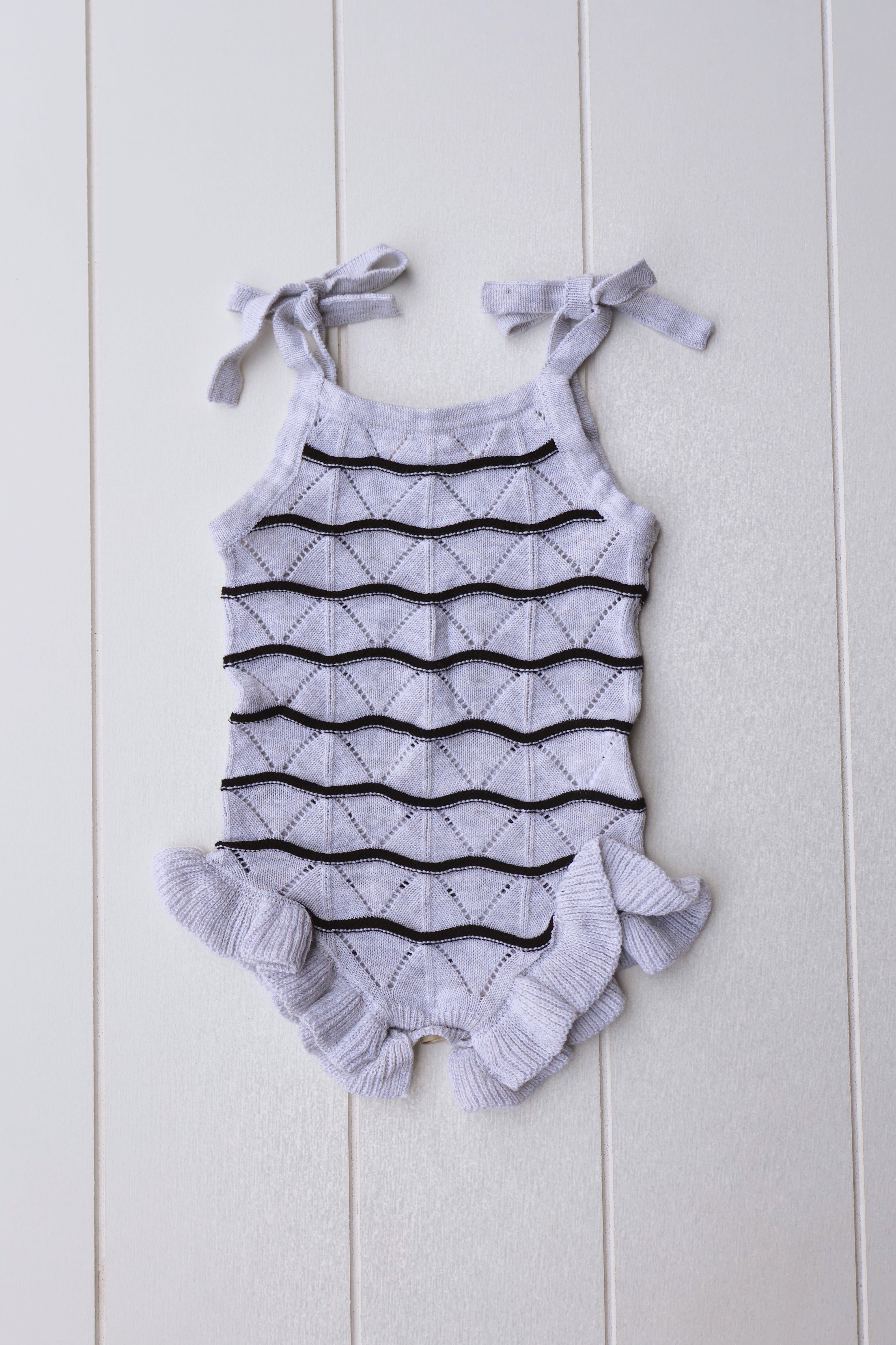 Spring Knit Ruffle Onesie for baby girls with ruffle sleeves and stylish knit design.
