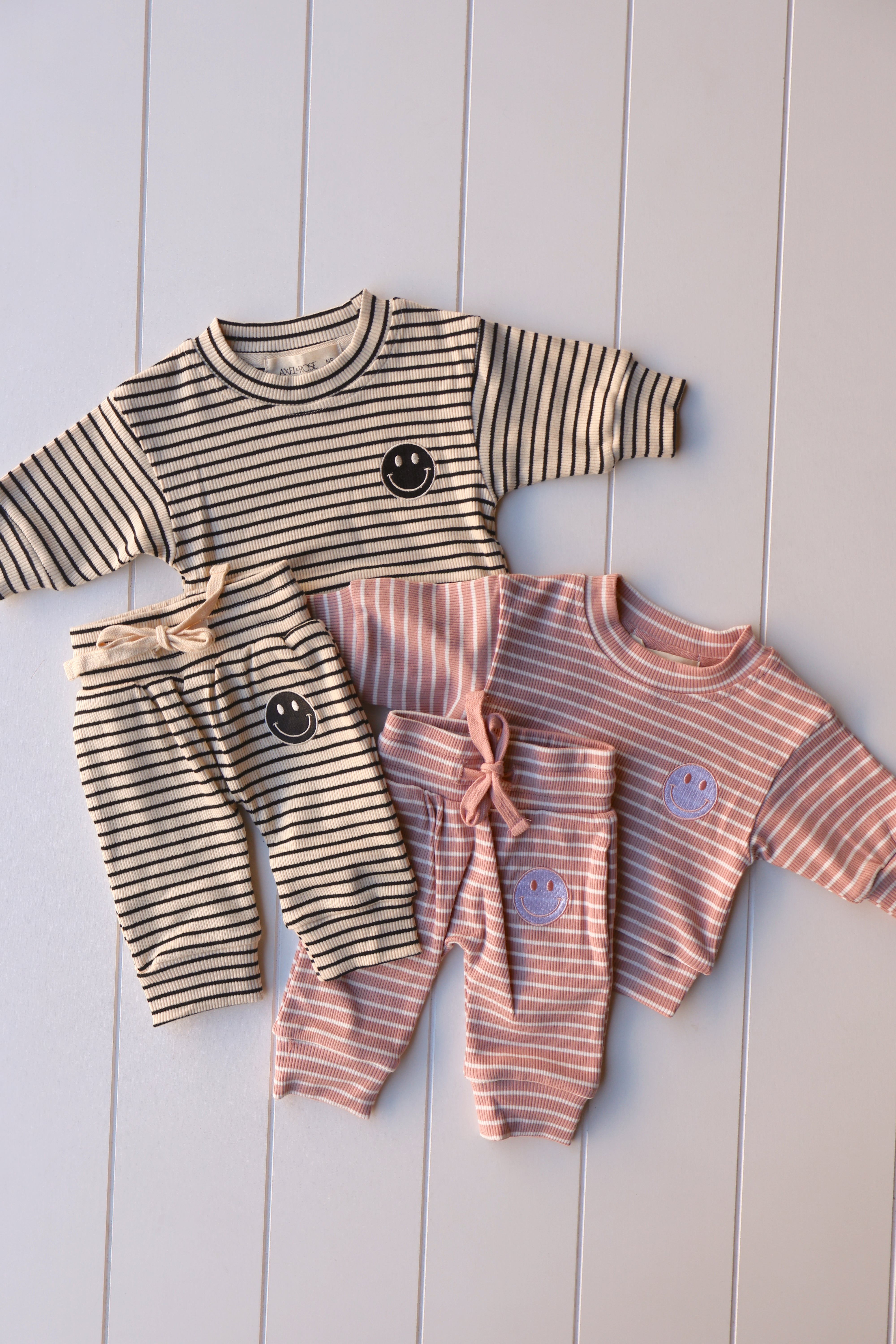 Smiley stripe set for toddlers and kids featuring striped tops and shorts in playful colors with smiley face graphics.