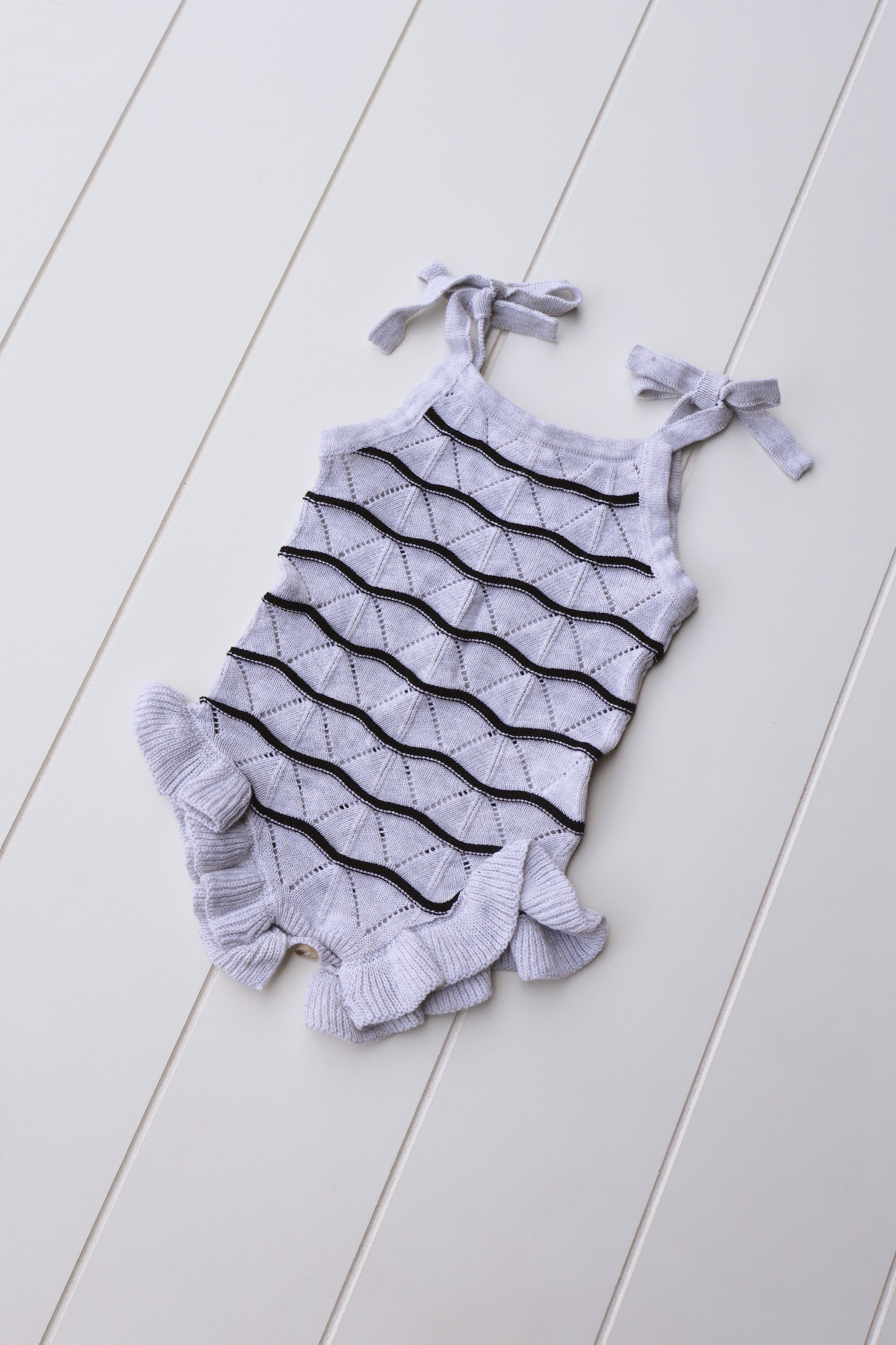 Spring Knit Ruffle Onesie for Baby Girls in soft knit with ruffle detail, perfect for spring days and special moments.