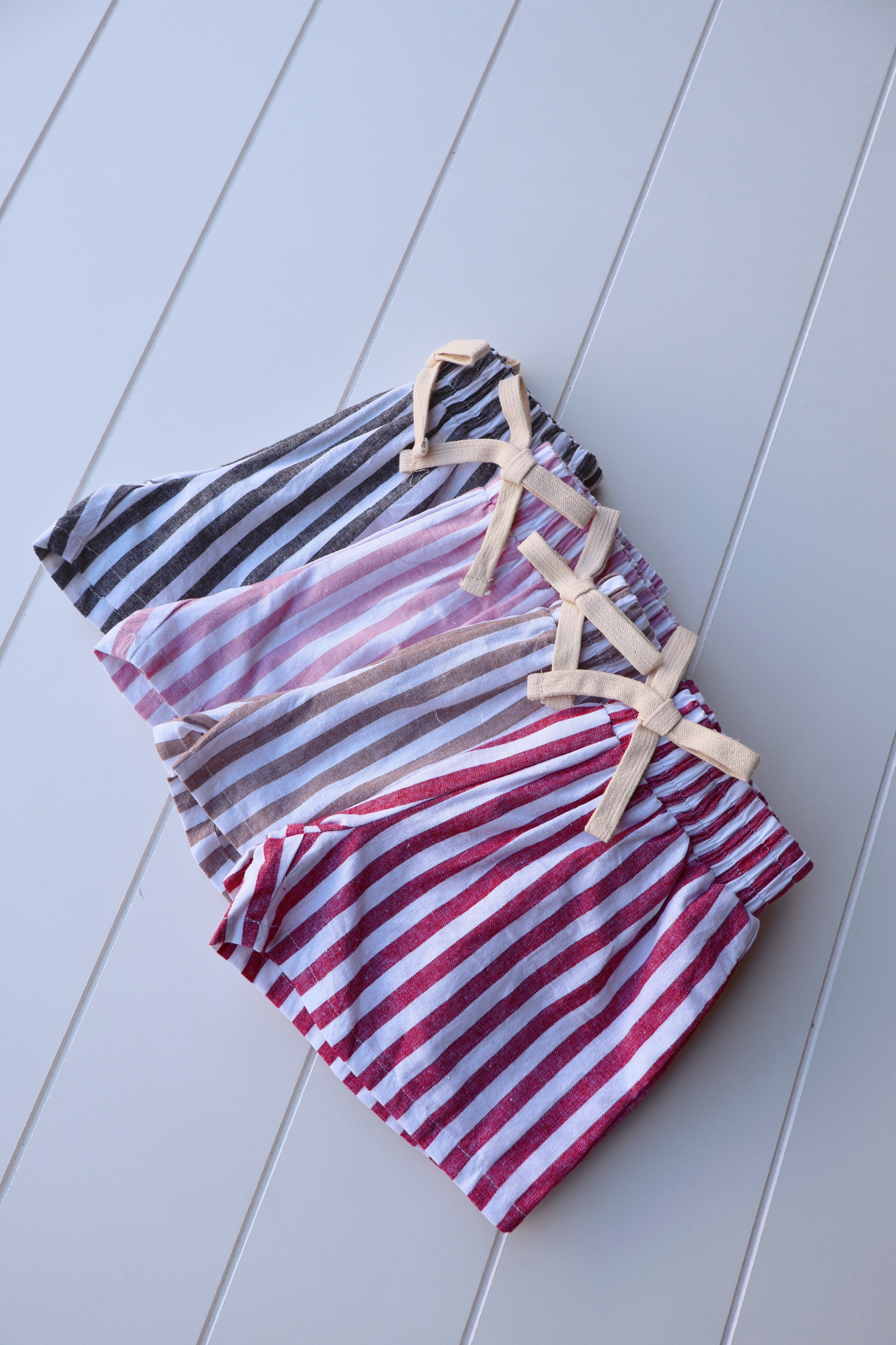 Vintage stripe shorts for toddlers in pink, gray, and red with soft elastic waistbands.