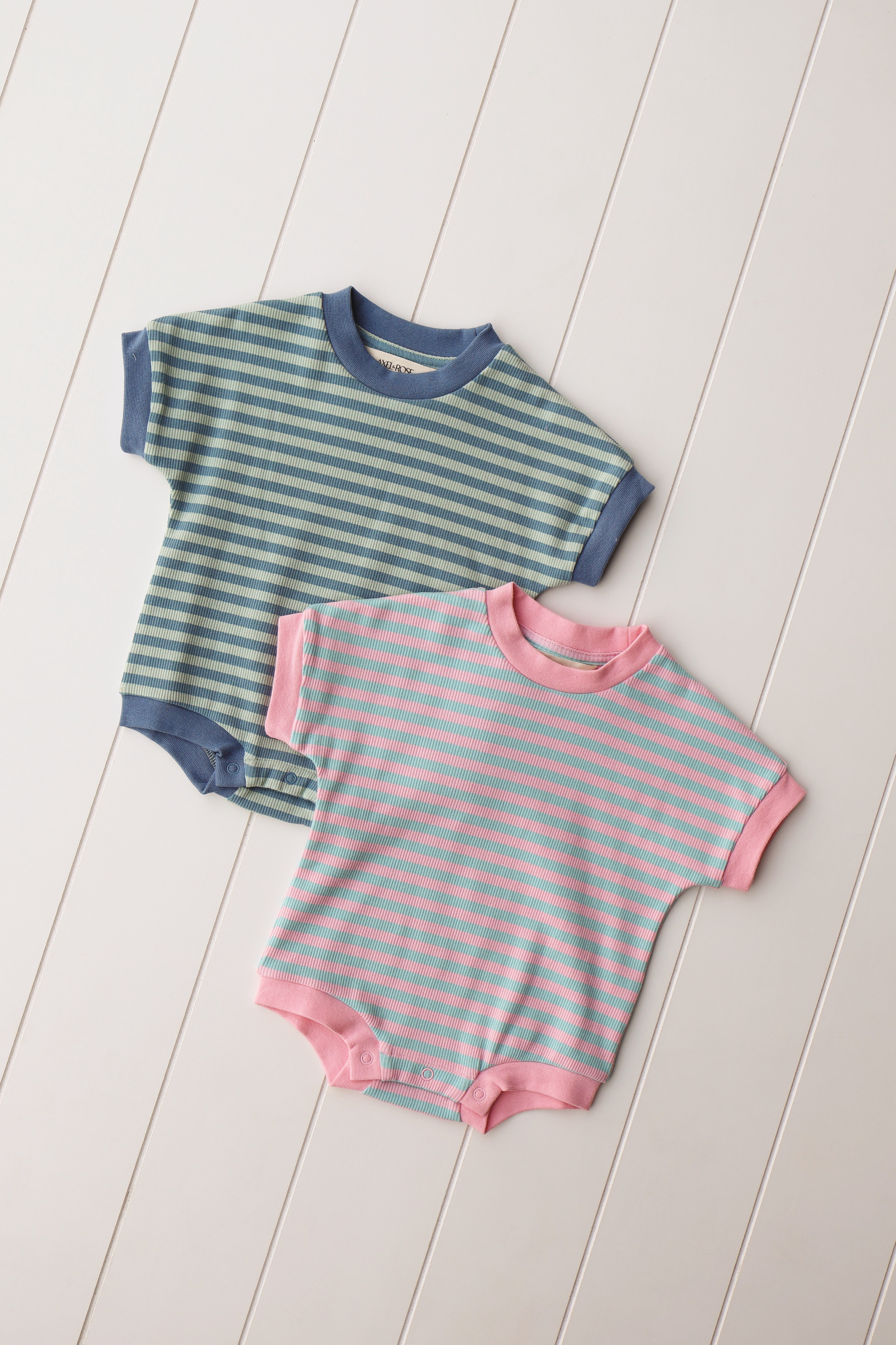 Cotton candy onesie set in pastel colors, featuring striped designs for babies, ideal for comfort and style.