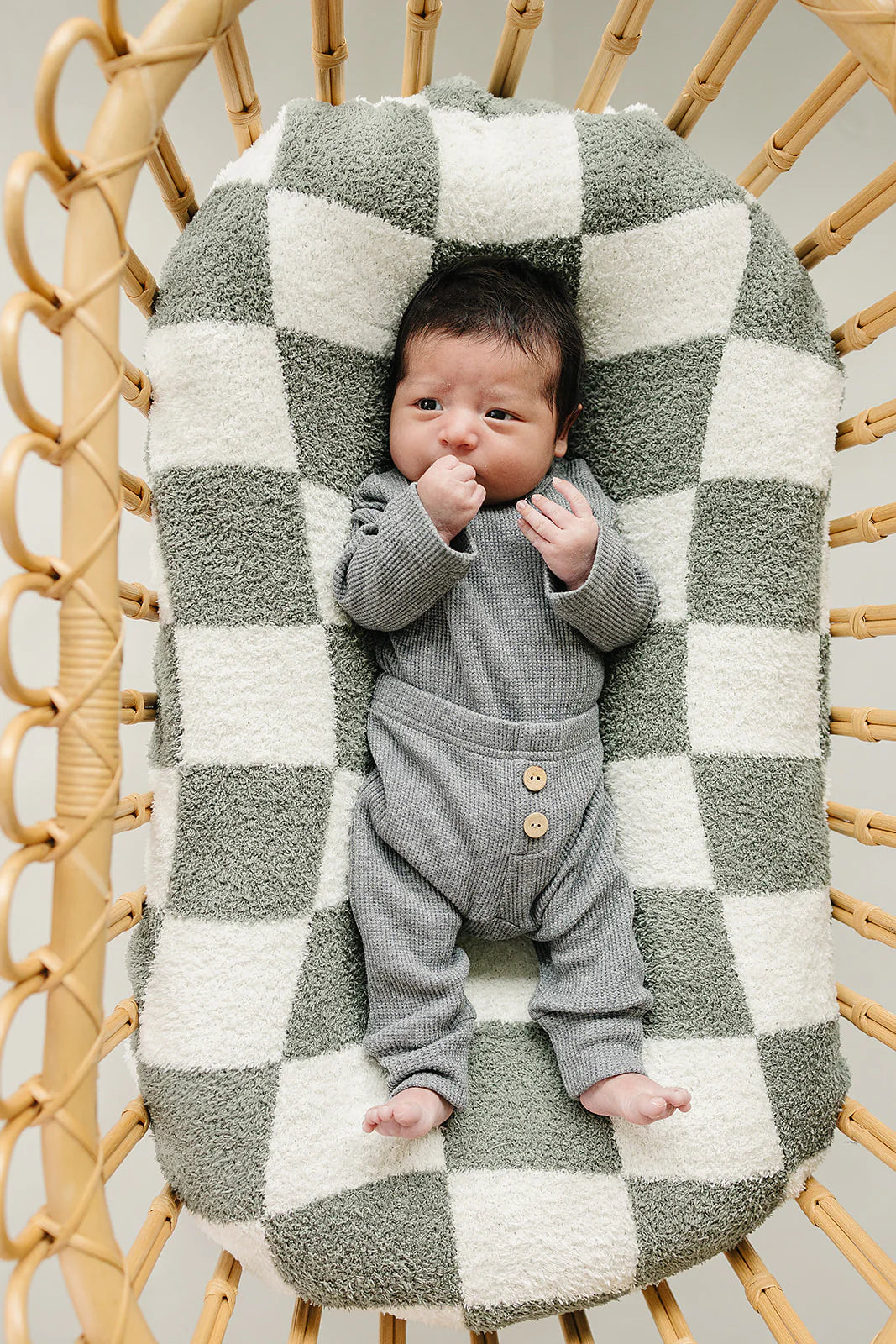 Waffle Knit Baby Bodysuit Set on a cozy checkered blanket, featuring a sweet baby in charcoal knit. Perfect for comfort.