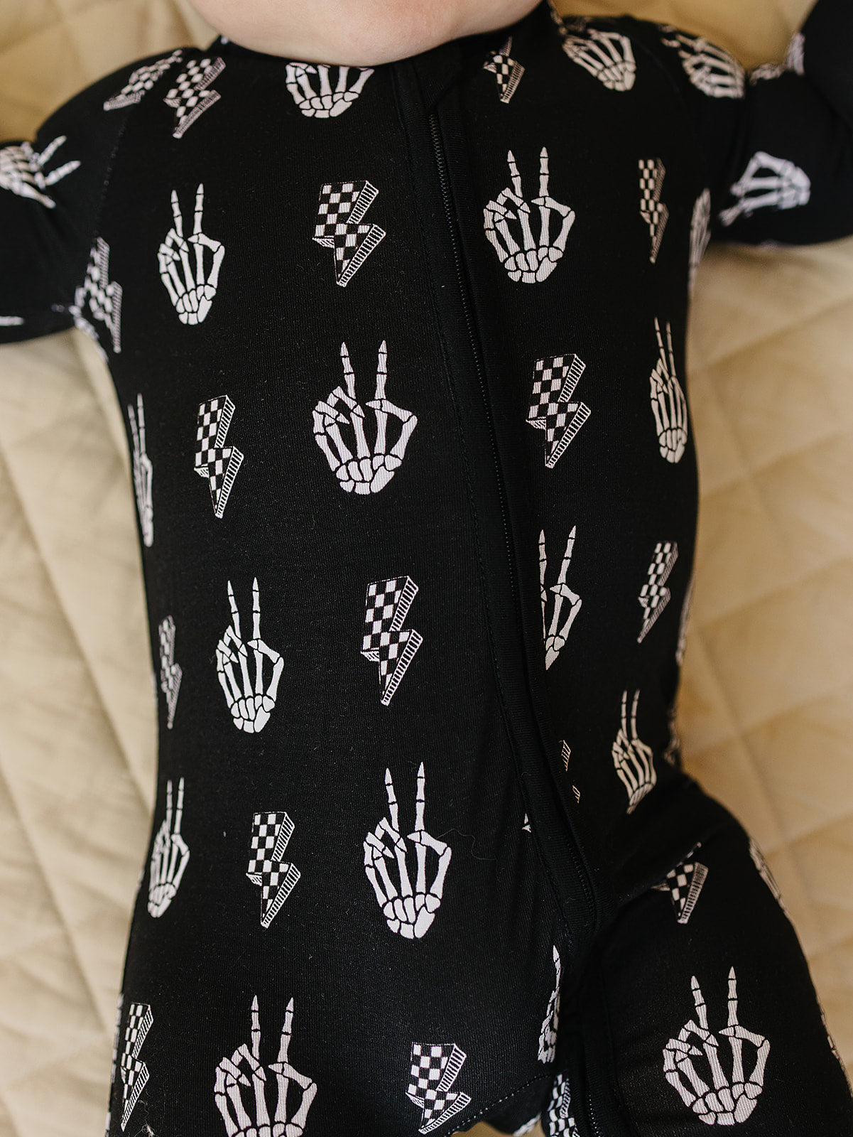 Bamboo Zip Romper Skelly Vibes with skeleton graphics for babies, featuring a cozy zip design in black.