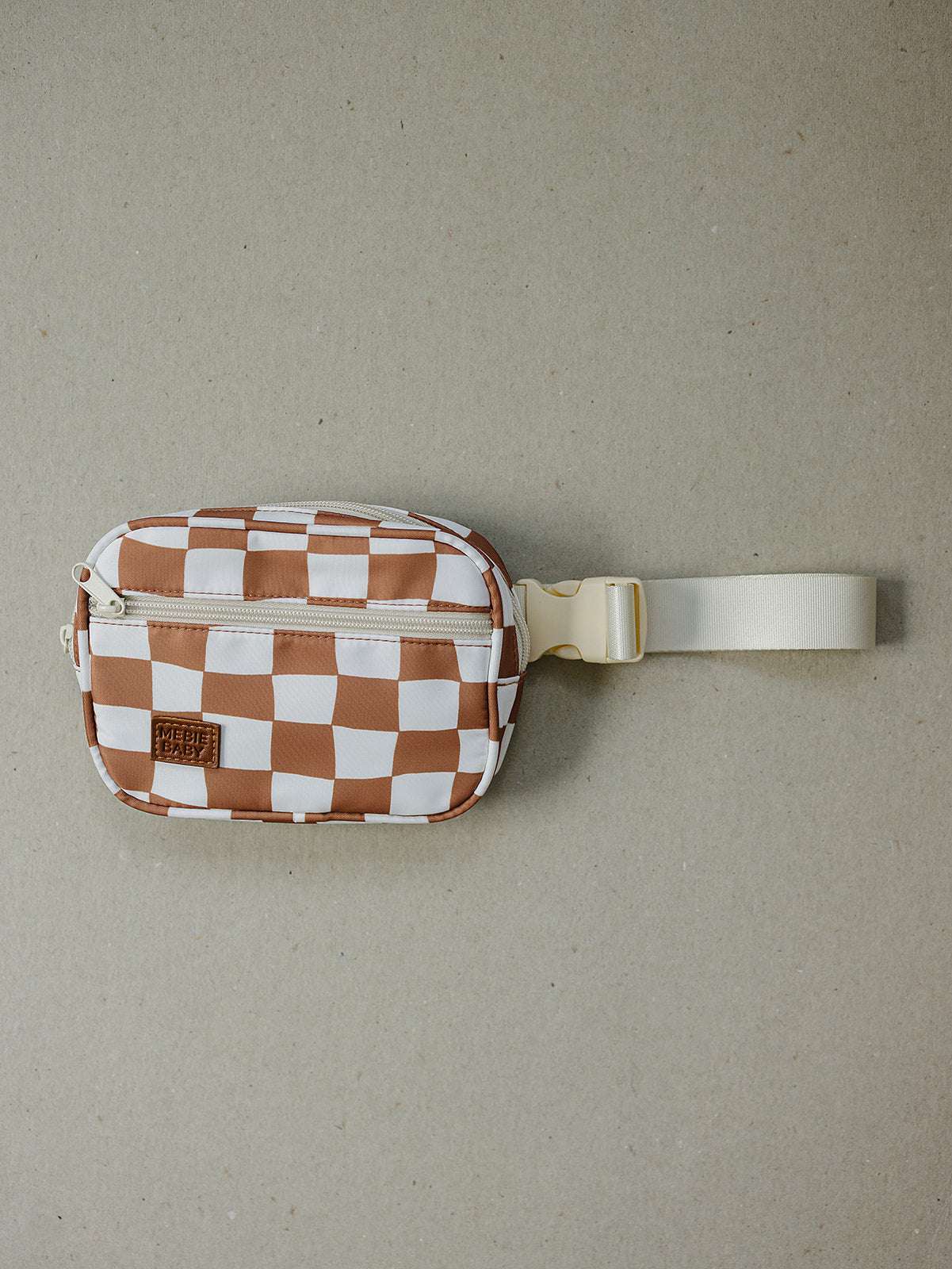 Rust checkered mini fanny pack with adjustable strap and zipper closure for hands-free fun and stylish outings.