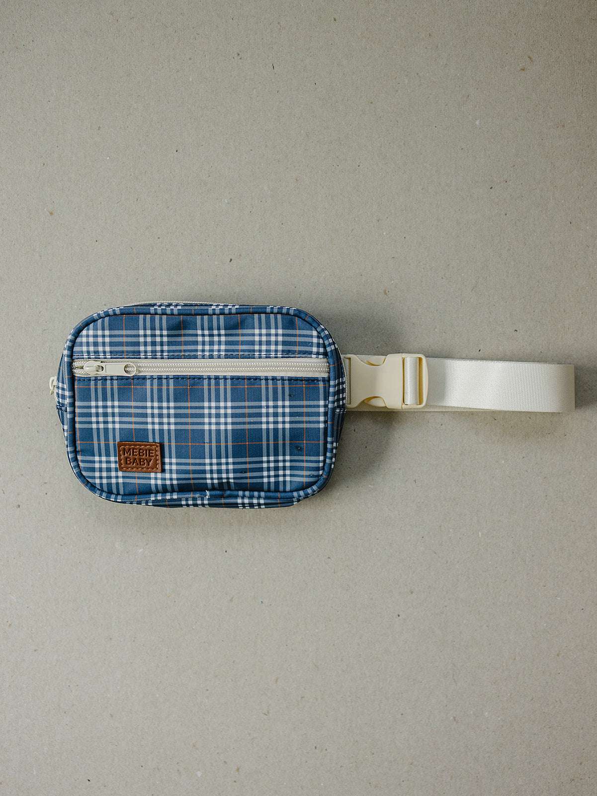 Navy plaid mini fanny pack with adjustable strap and zip closure, ideal for kids' outings and daily use.