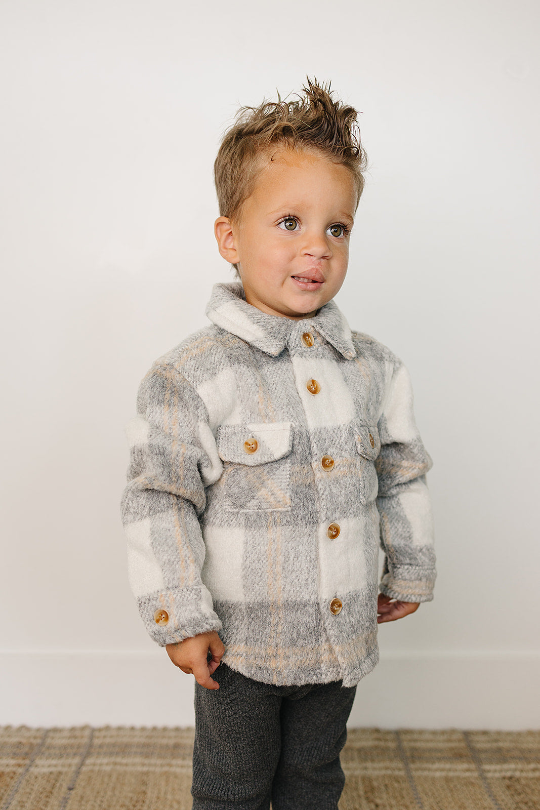 Baby wearing a stylish Grey Plaid kids shacket with wooden buttons, perfect for cool weather.