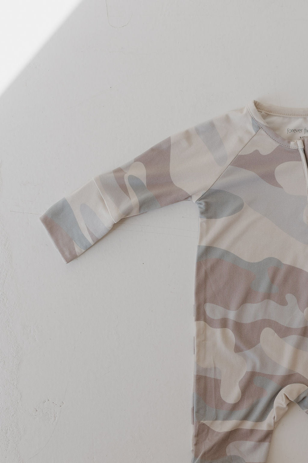 Bamboo zip pajamas in neutral camo print, featuring long sleeves and a double zipper for easy dressing.