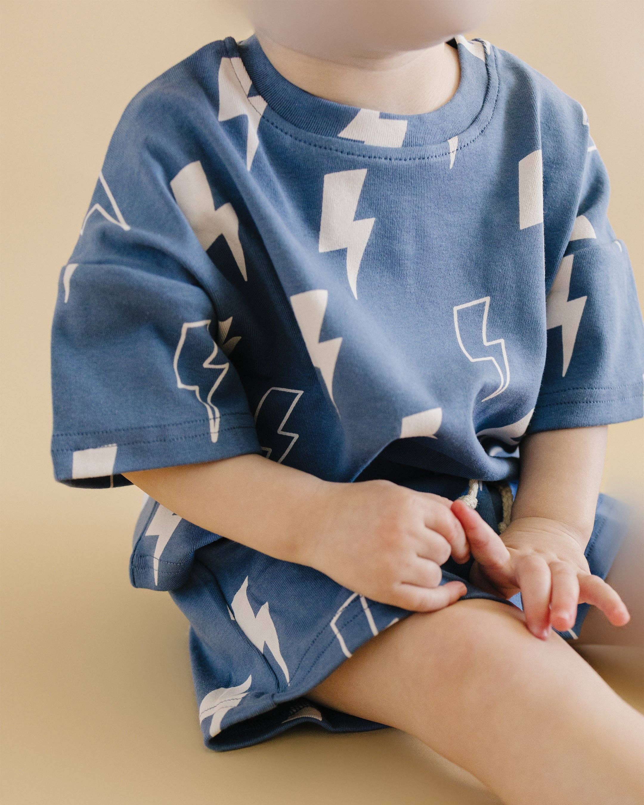 Toddler wearing Blue Bolts shorts set featuring lightning bolt print, soft fabric, and relaxed fit for comfort.