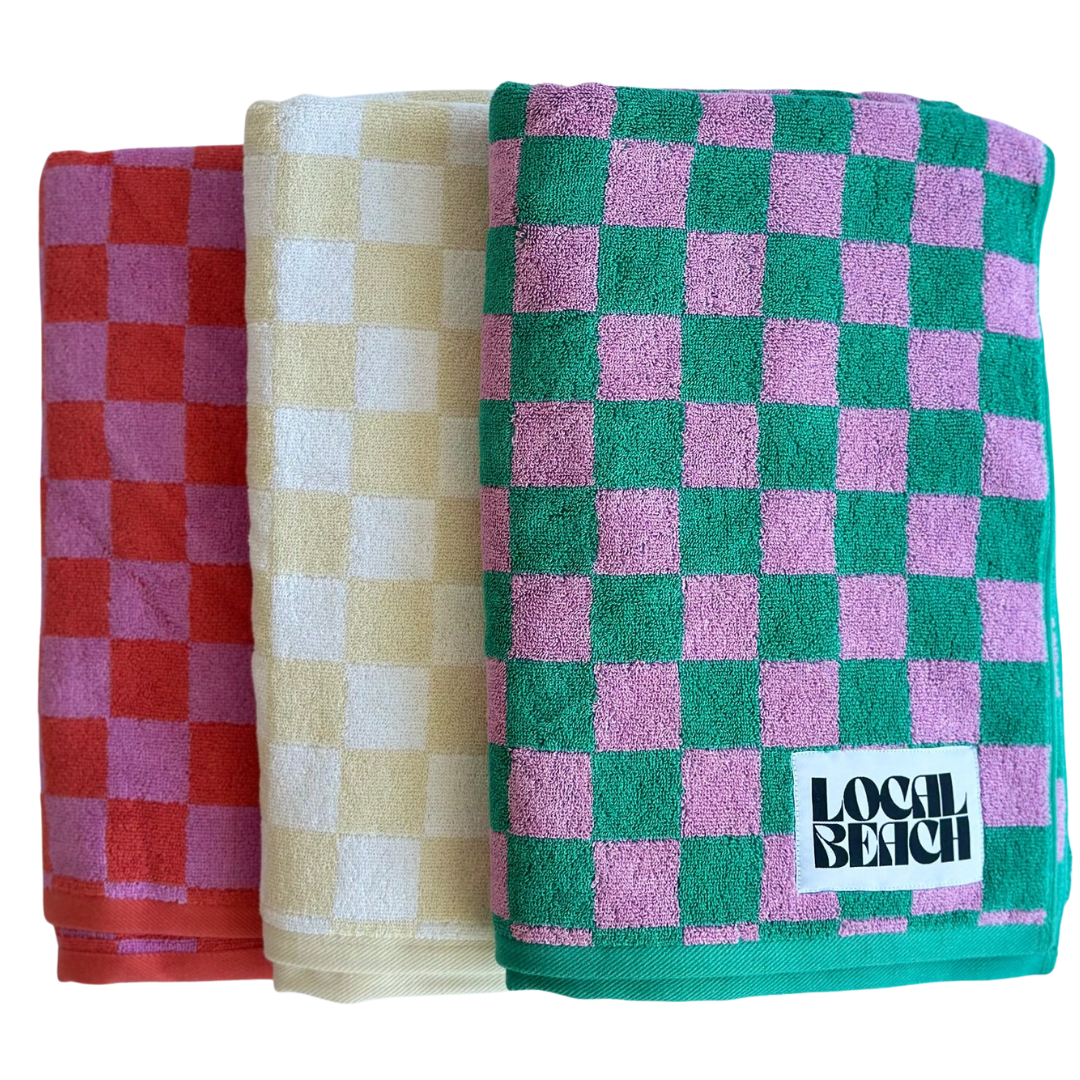 Checker Beach towels in red, yellow, and green, featuring bold checker patterns, perfect for beach and bath use.
