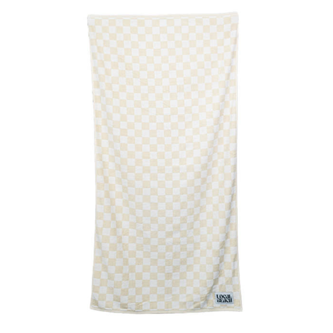 Soft oversized checker beach towel in a light beige and white pattern, perfect for beach and bath use.