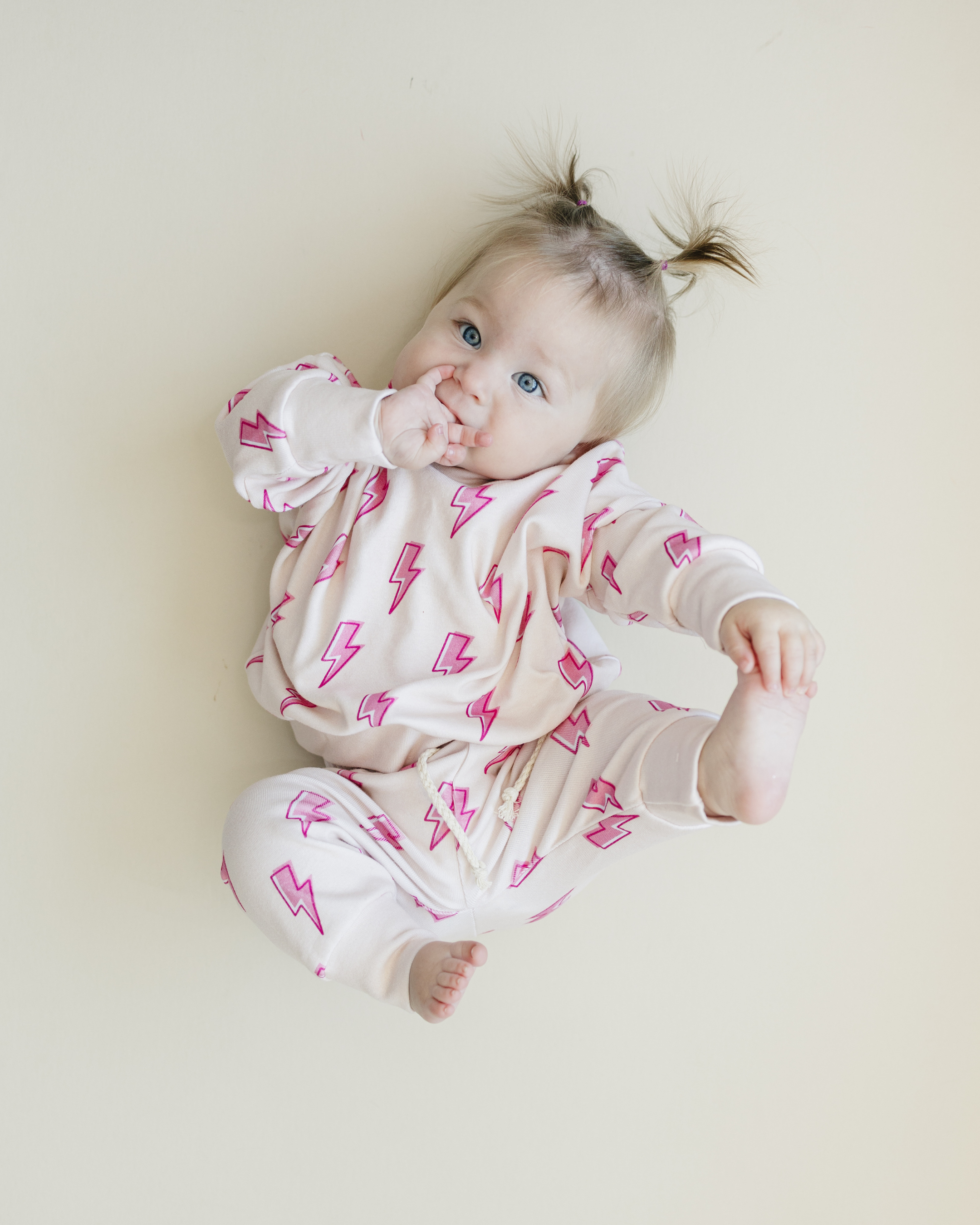 Toddler wearing pink bolt jogger set, showcasing a comfy, stylish, and relaxed fit with playful lightning bolt print.