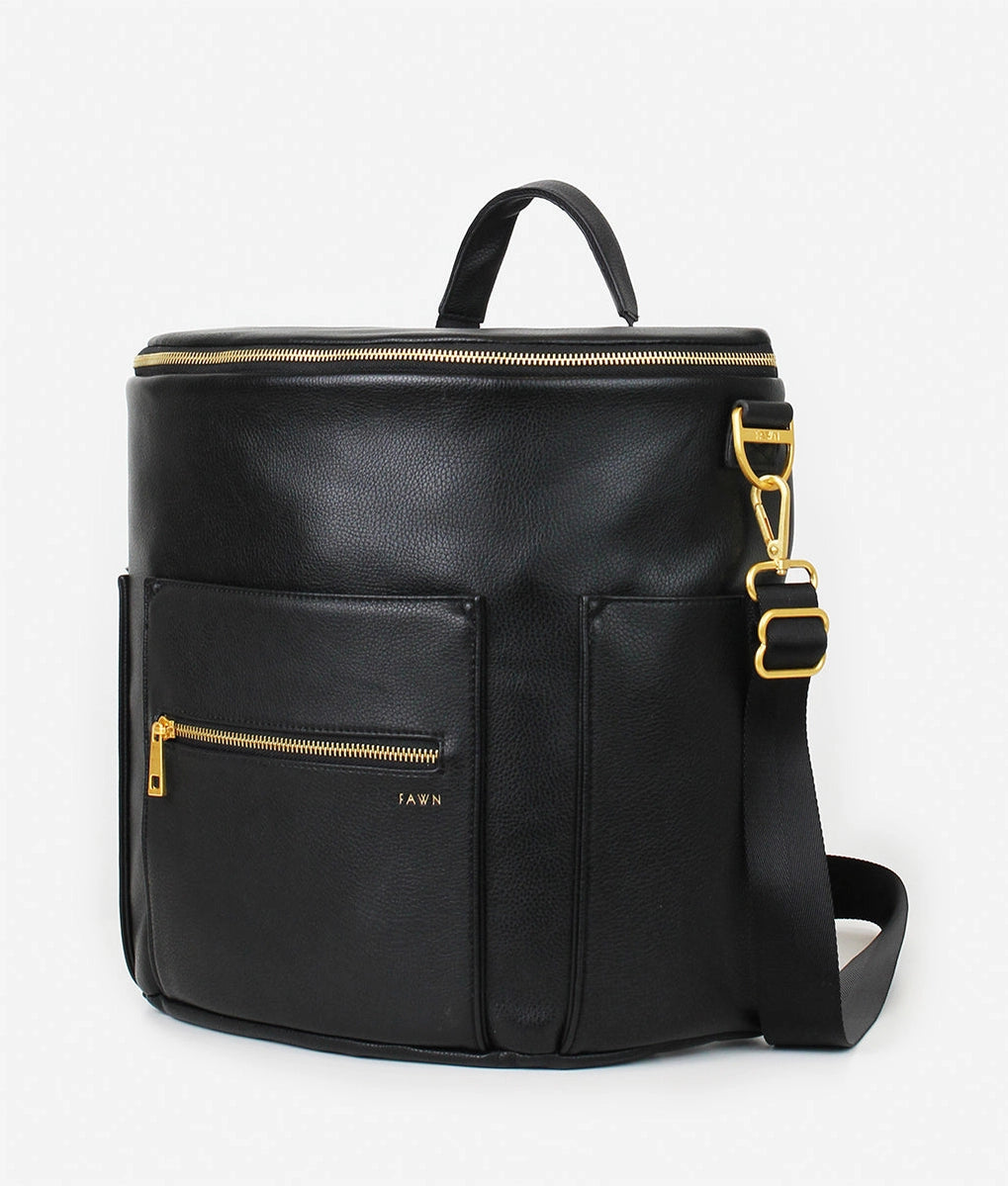 Original Diaper Bag Backpack in black faux leather with gold accents and multiple pockets.
