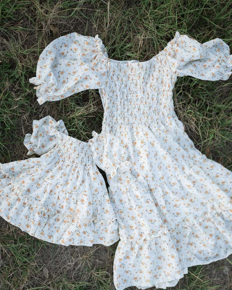Katherine matching yellow floral dress set for kids and moms with smocked bodice and flutter sleeves.