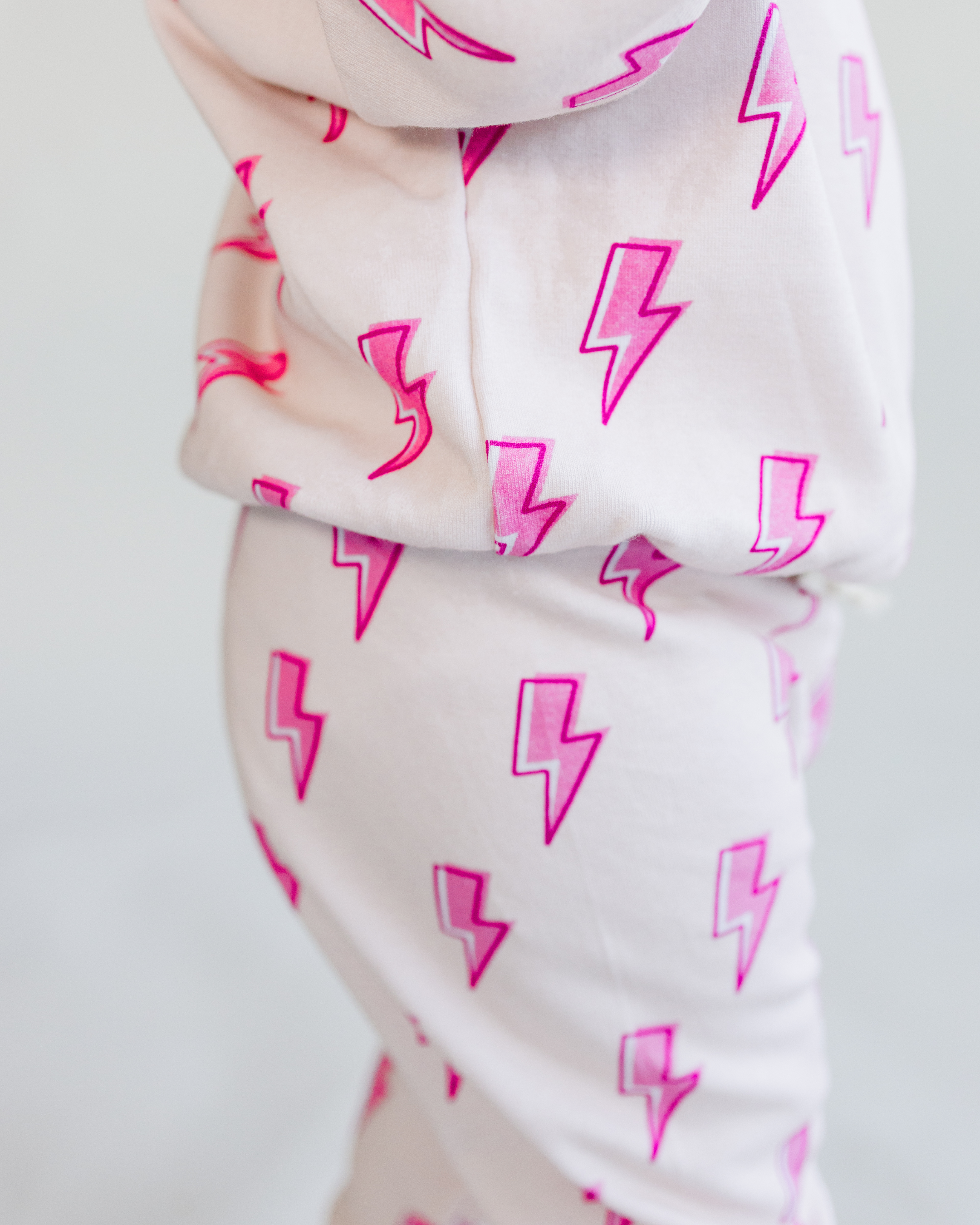 Toddler in pink bolt jogger set with electric pink lightning print, showcasing comfy and trendy kids loungewear.