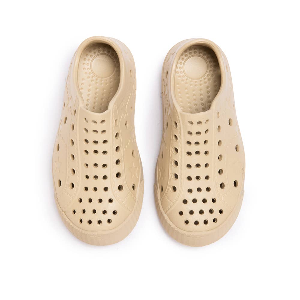 Beige waterproof toddler sneakers with perforated design for breathability and comfort.