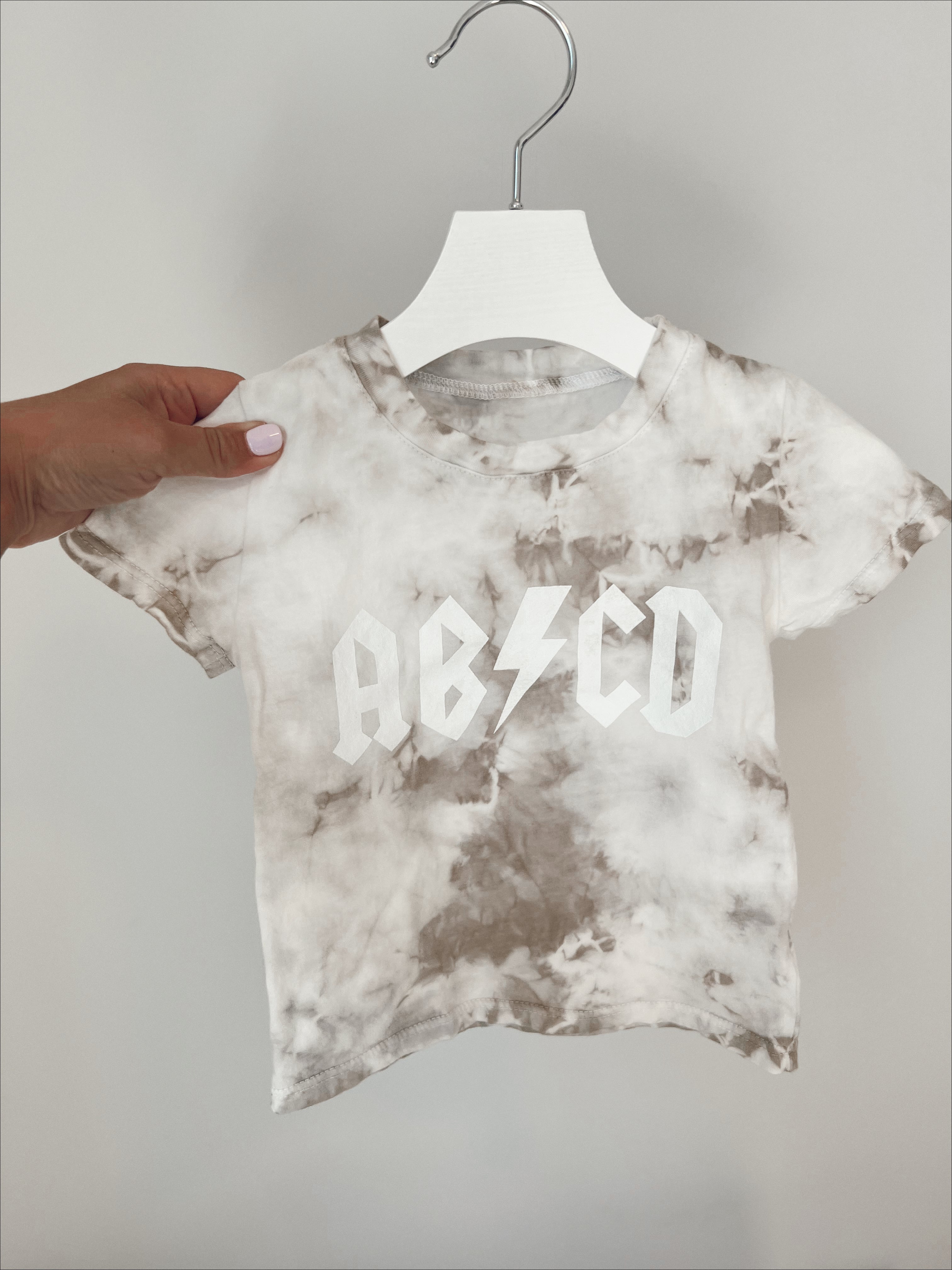 ABCD Tie Dye Tee in light brown with a lightning bolt design, perfect for baby and toddler playwear.