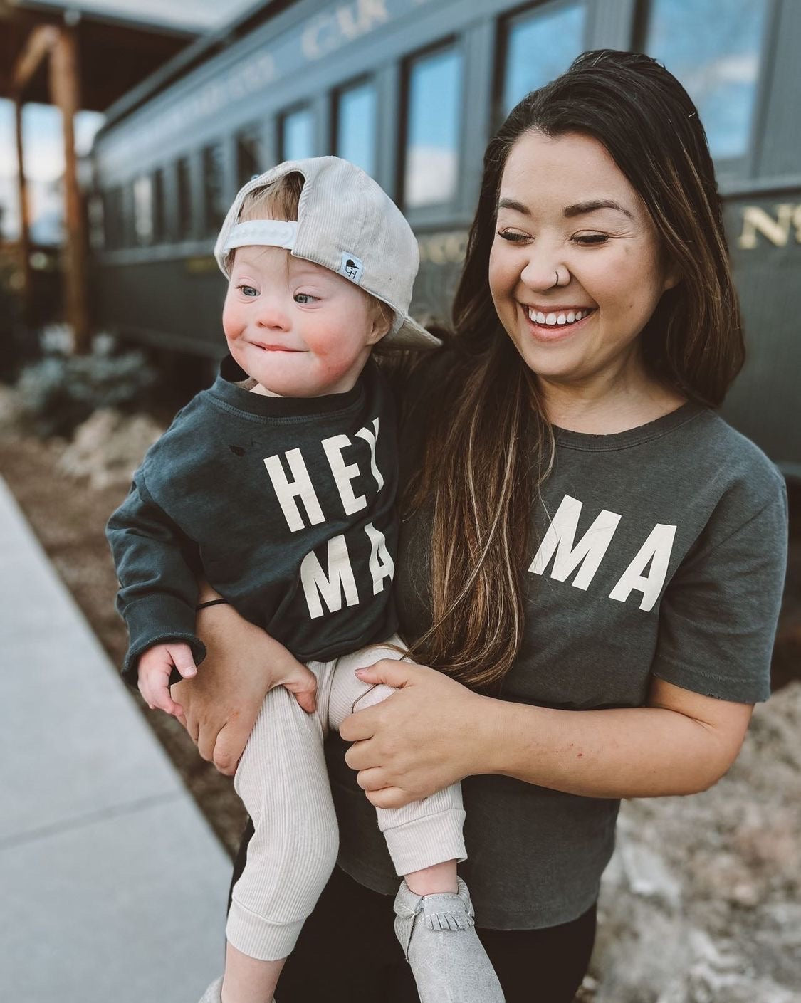 Mom and child wearing matching Hey Ma kids sweatshirts, showcasing playful family style and comfort.