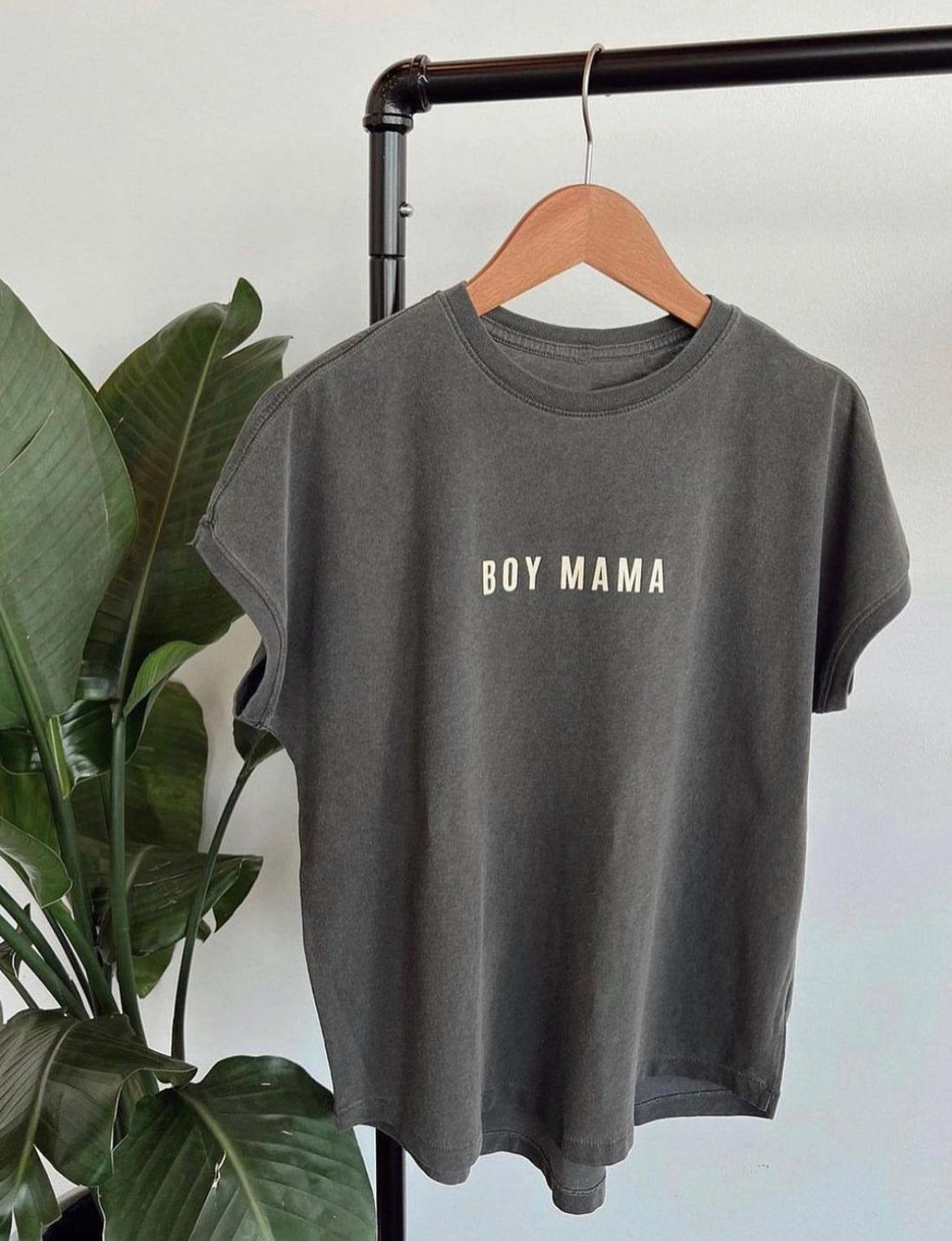 Boy Mama graphic tee displayed on a hanger, featuring a relaxed fit and neutral design, perfect for trendy moms.