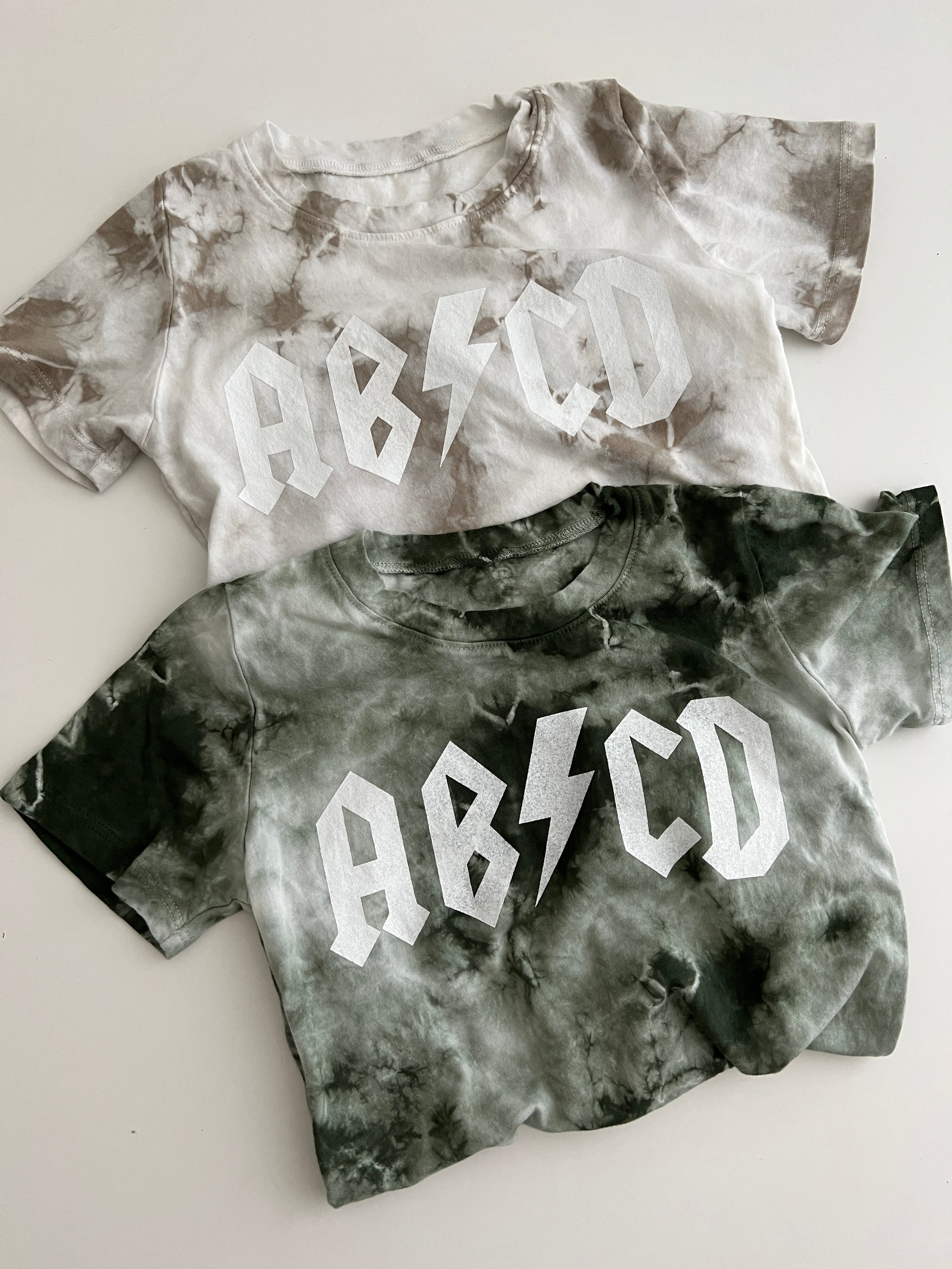 ABCD Tie Dye Tee in earthy tones, featuring bold ABCD design, perfect for stylish baby and toddler wear.