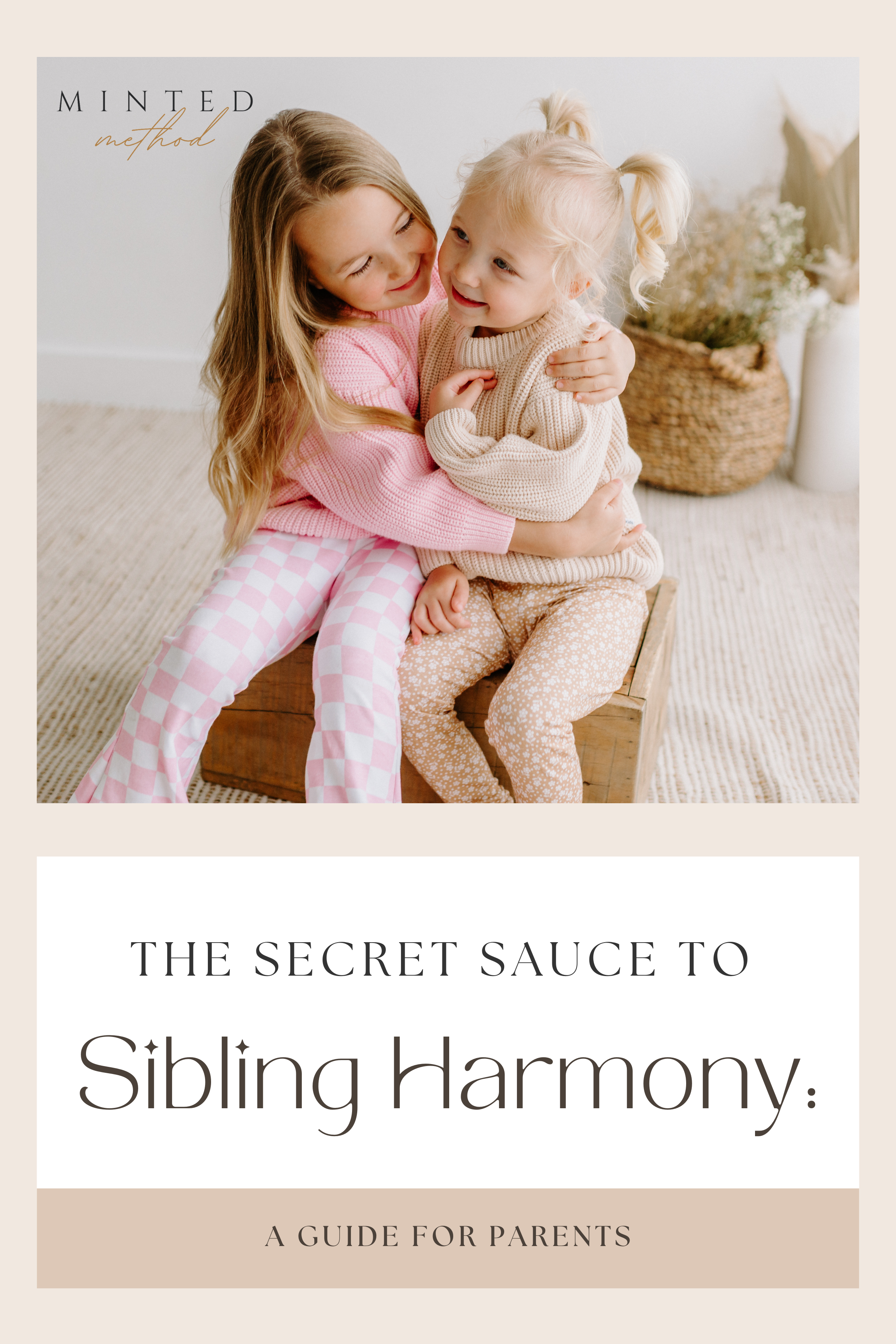 Two young sisters hugging and smiling in neutral and pastel loungewear, promoting sibling bonding and gentle parenting.
