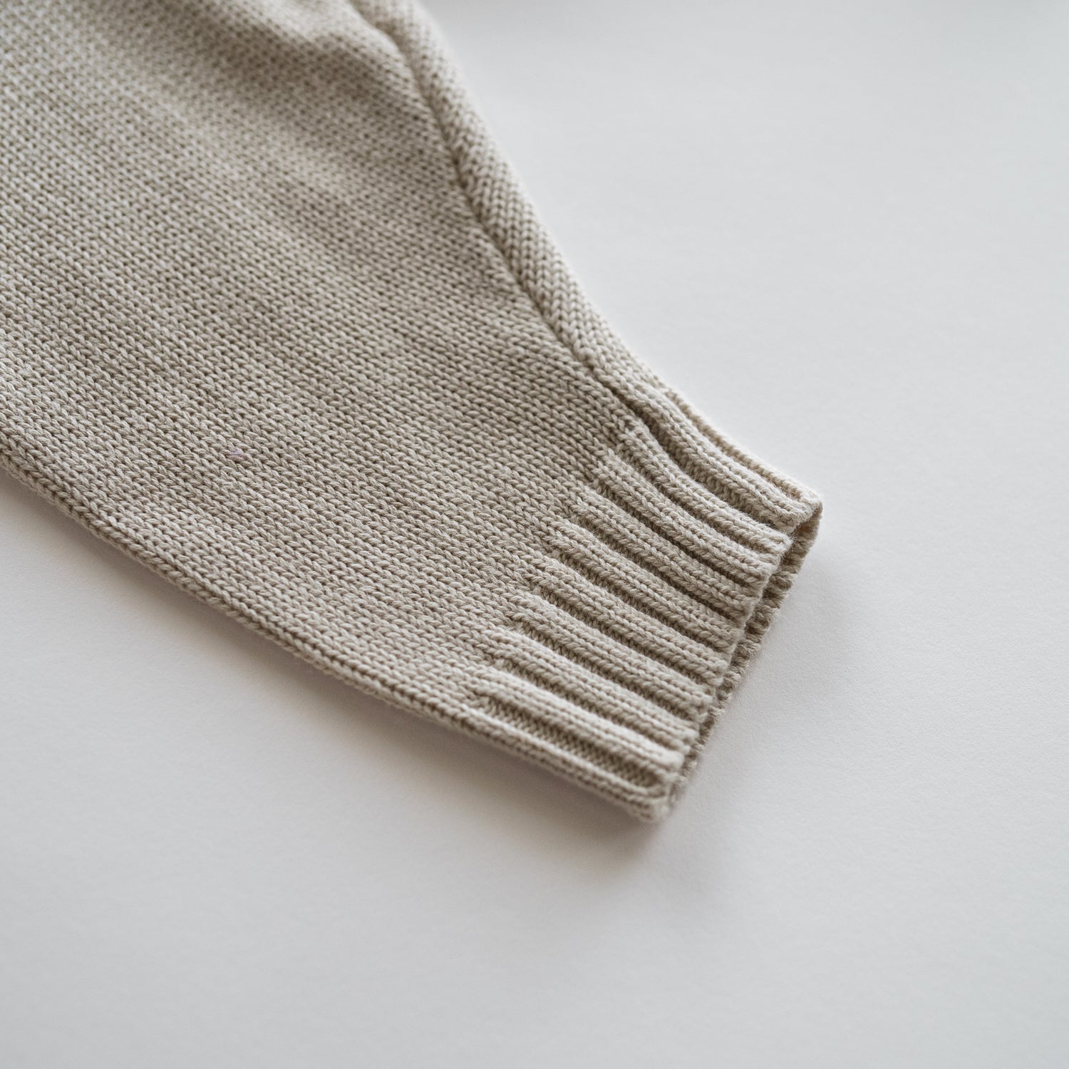 Close-up of the cuff of the Organic Knit Oversized Pant showcasing soft, textured knit in a neutral tone.