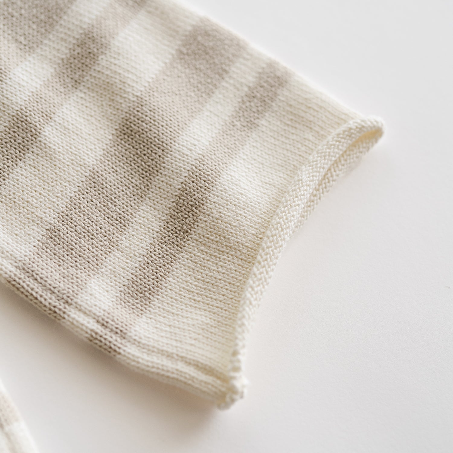 Close-up of the Organic Knit Wideleg Pant showing the soft, earthy striped pattern in linen and ecru tones.