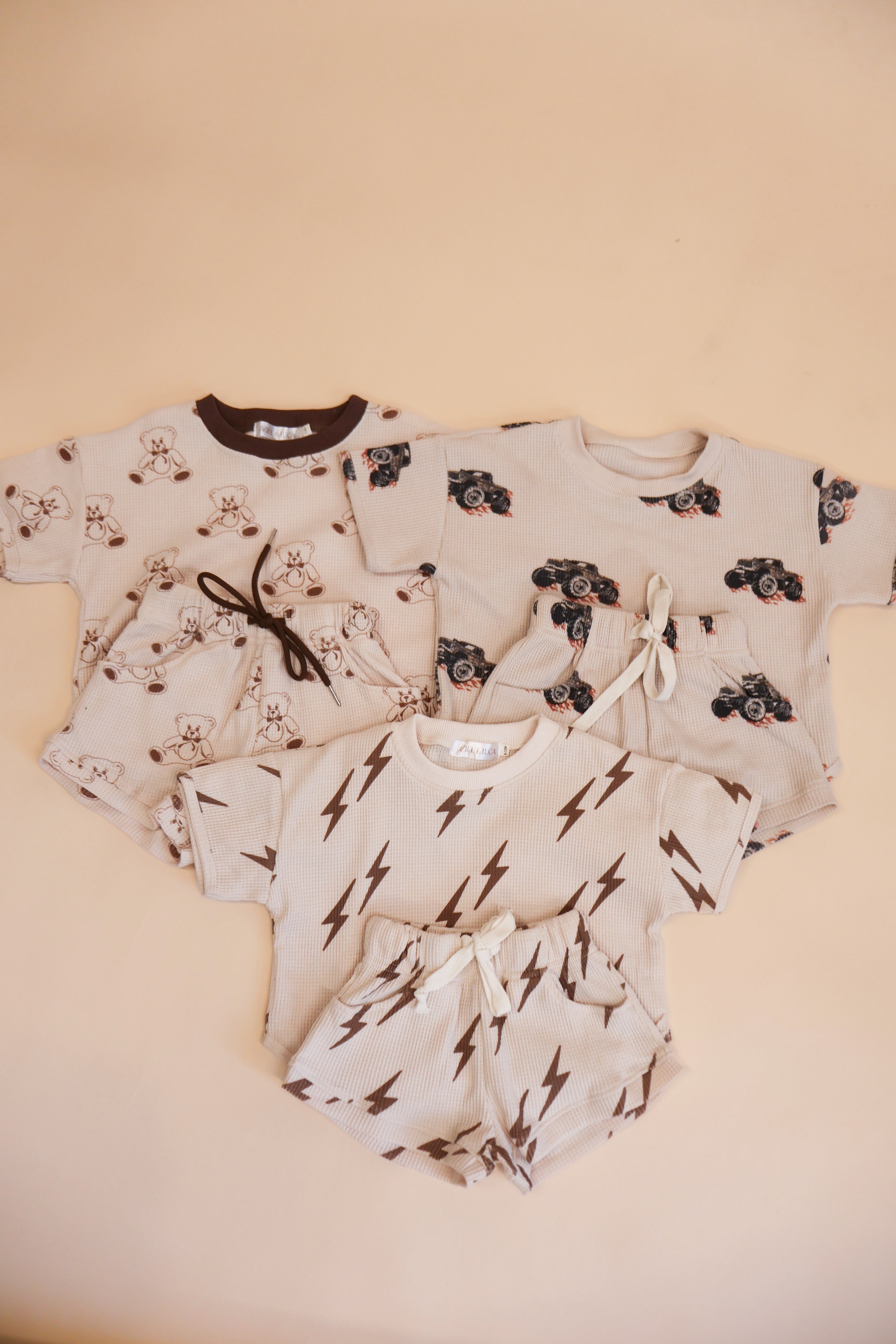 Printed waffle sets for kids featuring playful designs: Bear, Bolt, and Monster Truck patterns in soft fabrics.