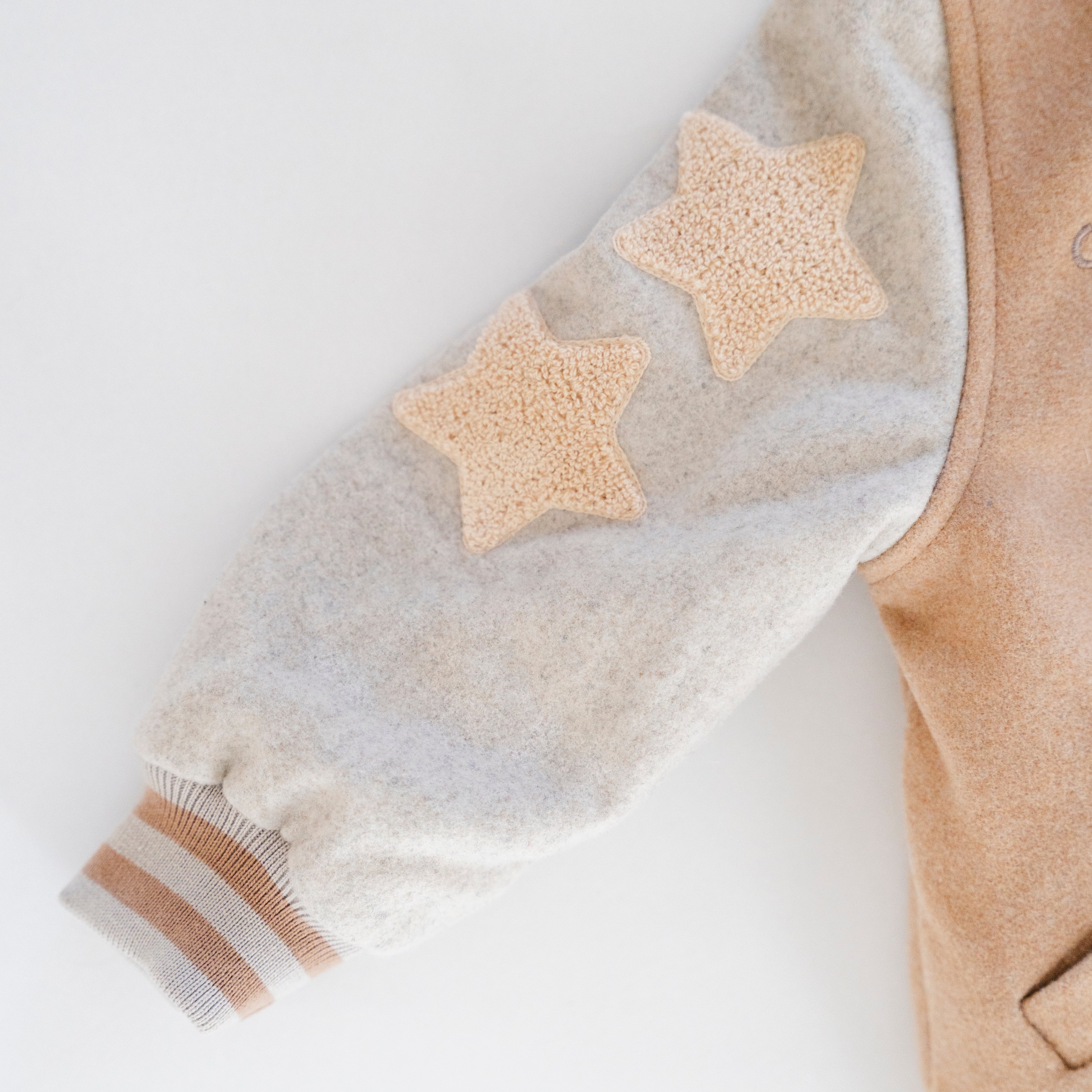 Letterman Jacket with star patches and striped cuffs for kids' classic varsity style.