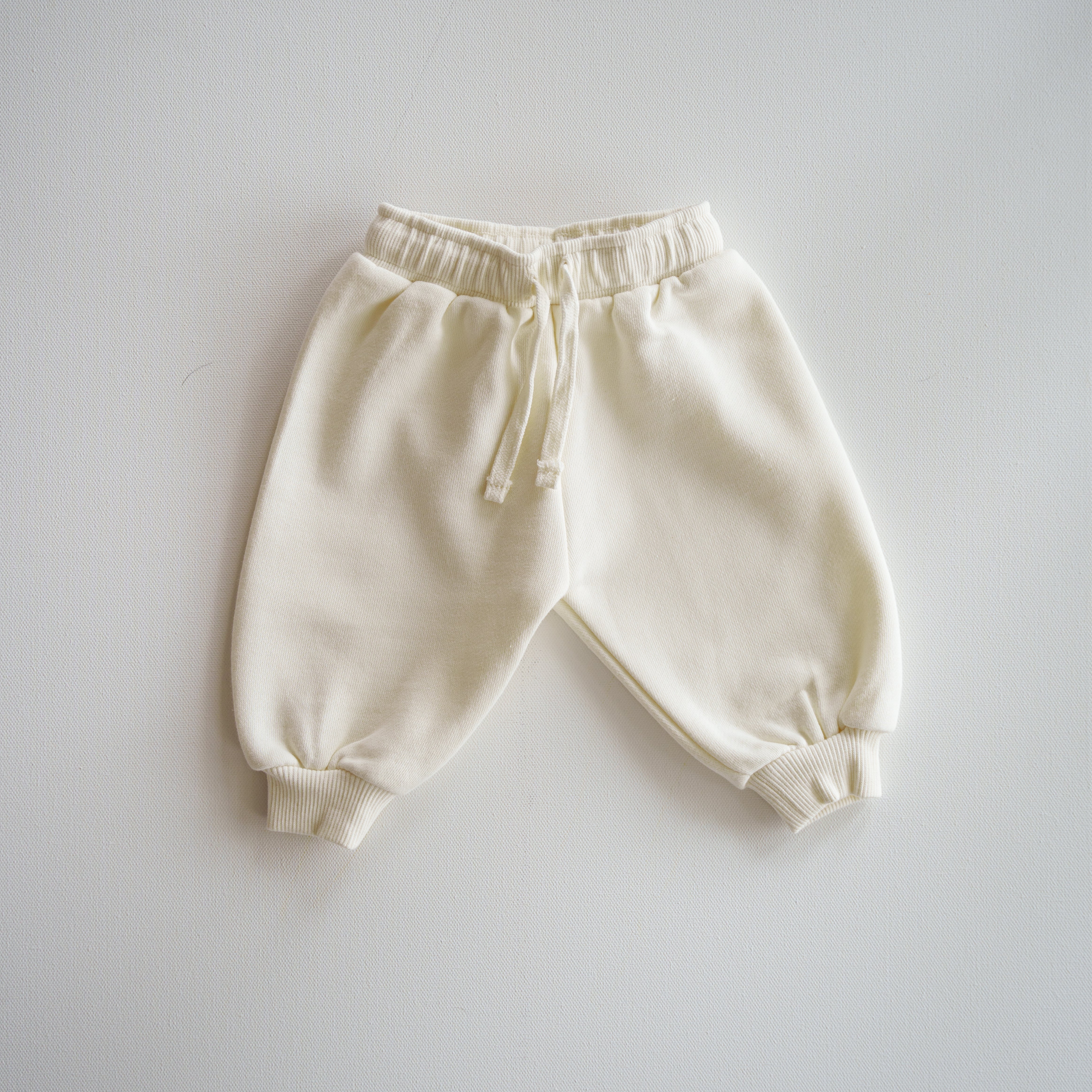 Oversized Sweatpant in soft cream color, perfect cozy bottoms for babies and kids.