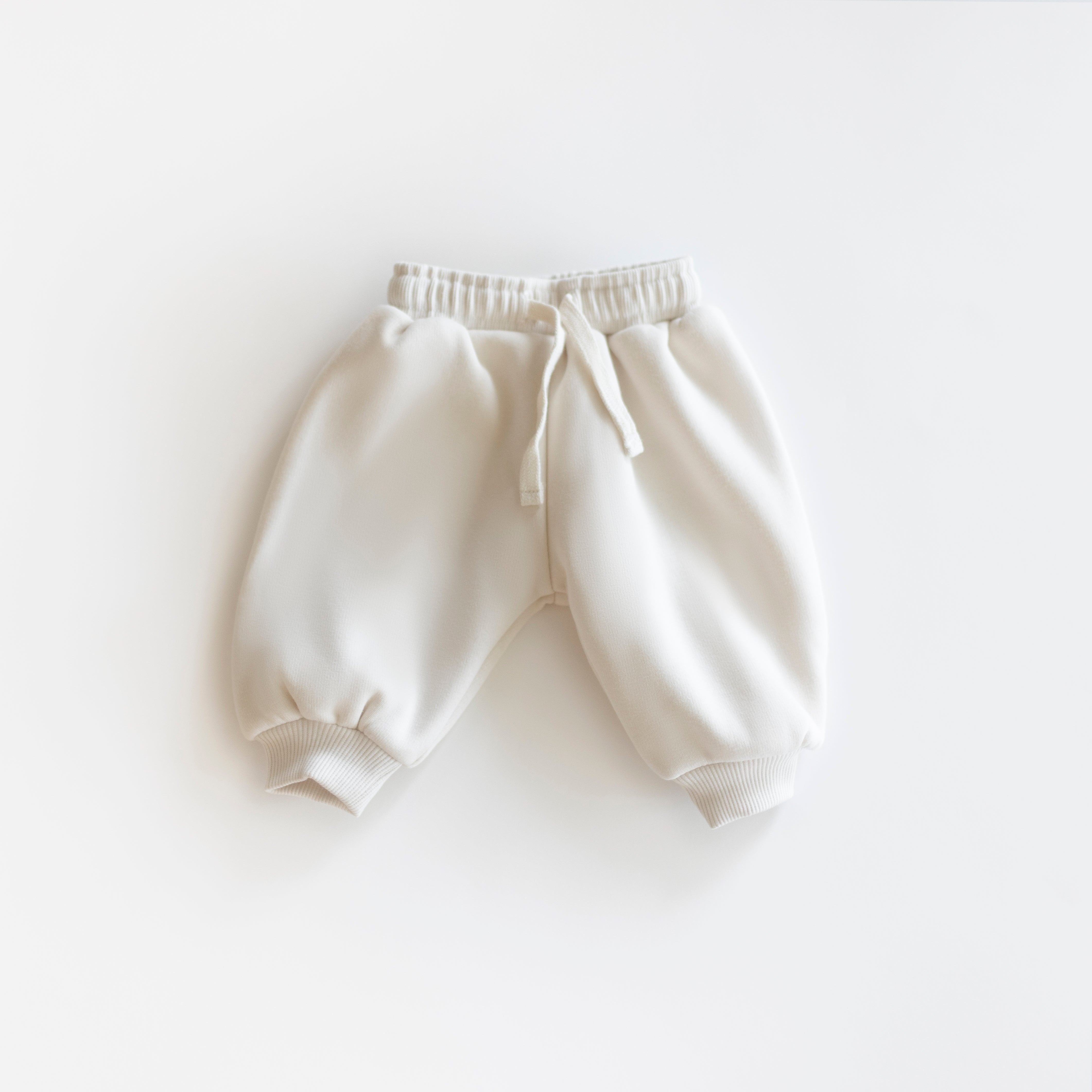 Oversized Sweatpant - Cozy neutral sweatpants for babies and kids on a white background.