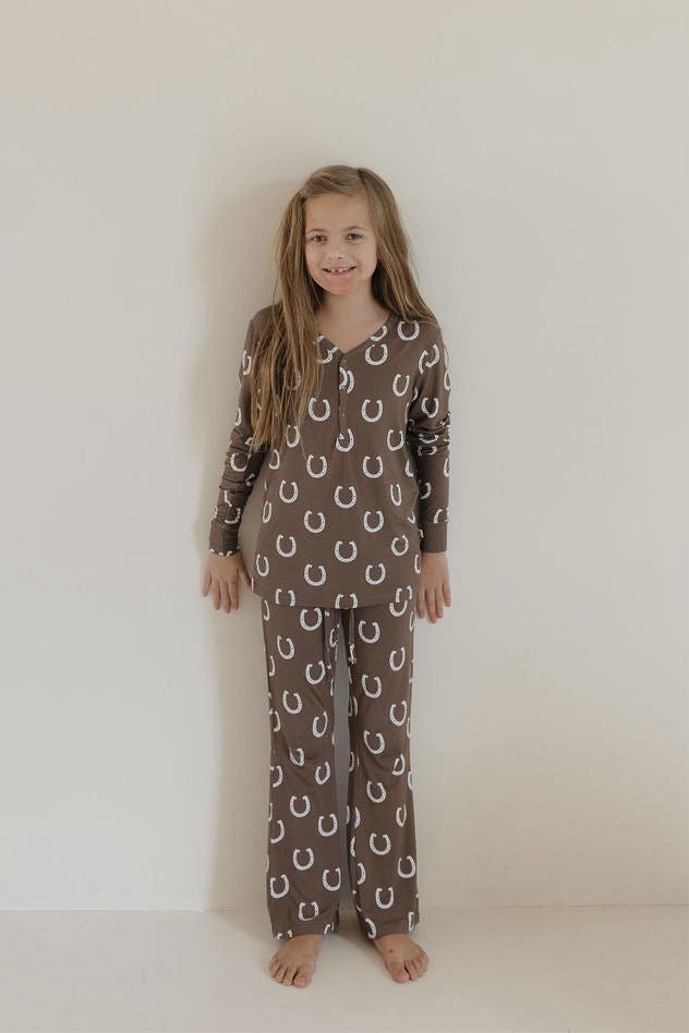 Youth flare bamboo pajamas giddy up featuring a brown-horseshoe print, perfect for stylish sleepovers and cozy lounging.