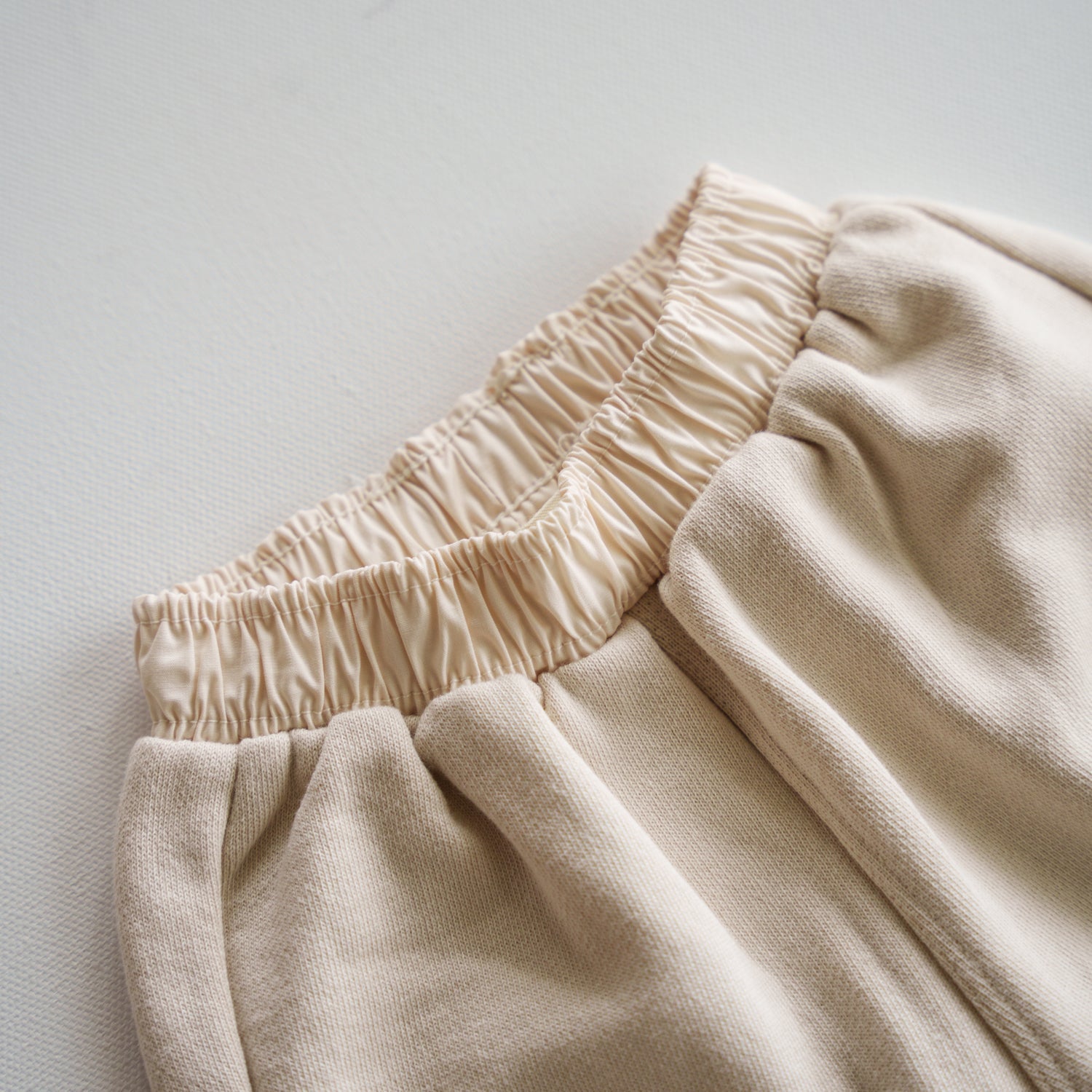Close-up of the waistband of the Cargo Wideleg Pant in soft neutral fabric, highlighting its relaxed fit and comfort.