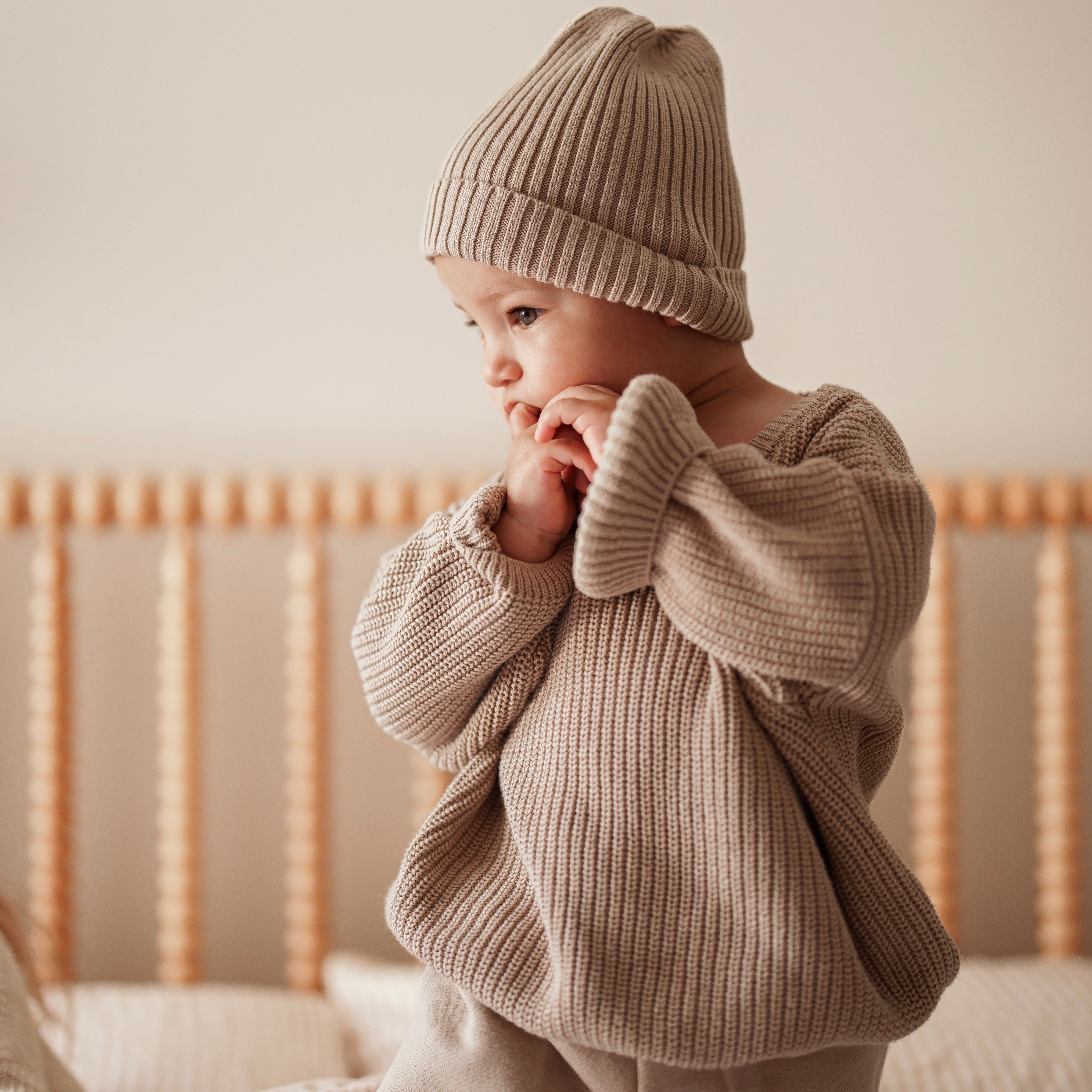 Baby wearing an Organic Chunky Knit Sweater in neutral color, showcasing stylish comfort.